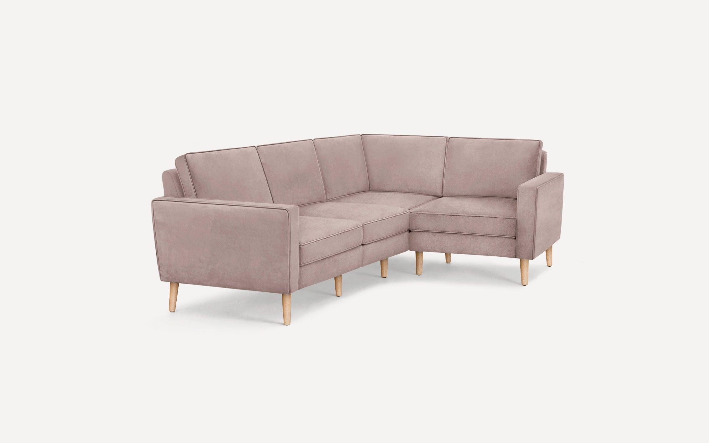 Light mauve sectional sofa with clean lines, wooden legs, and plush cushions, ideal for modern living spaces.