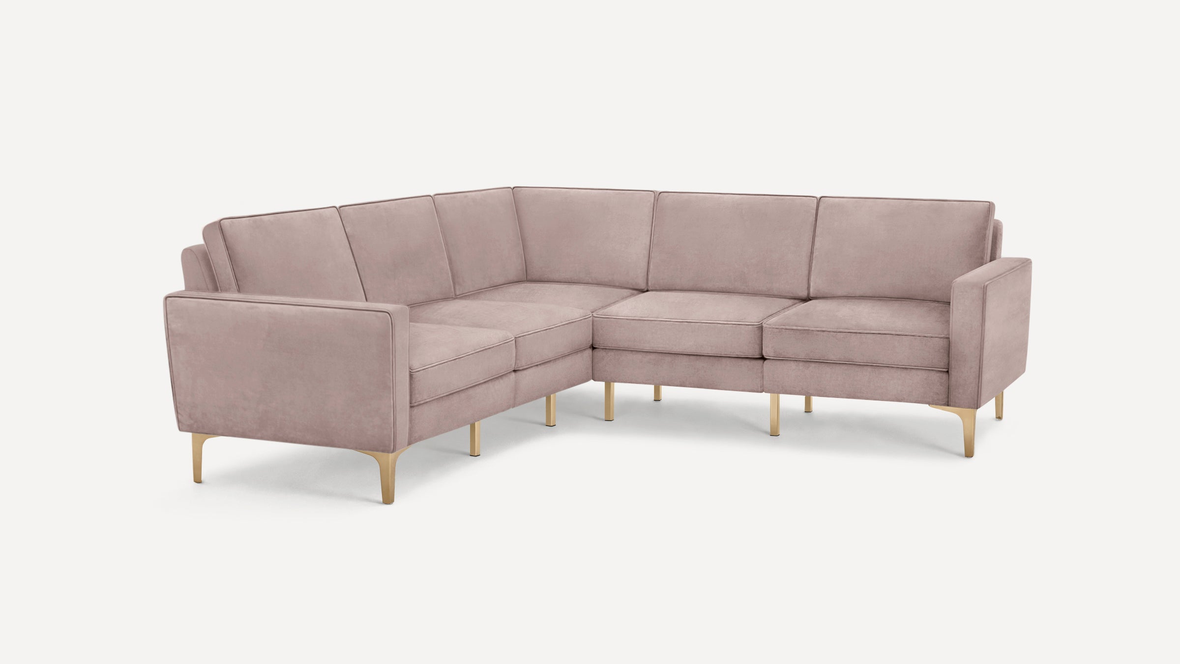 Modern L-shaped sectional sofa in soft pink velvet with gold metal legs, featuring clean lines and cushioned seats and backs.