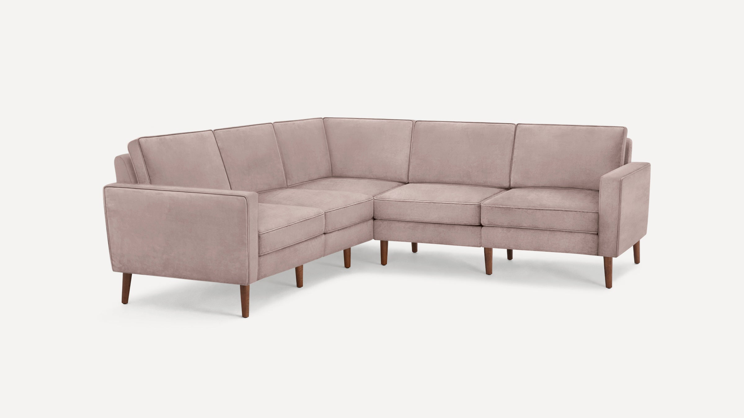 L-shaped sectional sofa with dusty pink upholstery, clean lines, and wooden tapered legs, designed for modern living spaces.