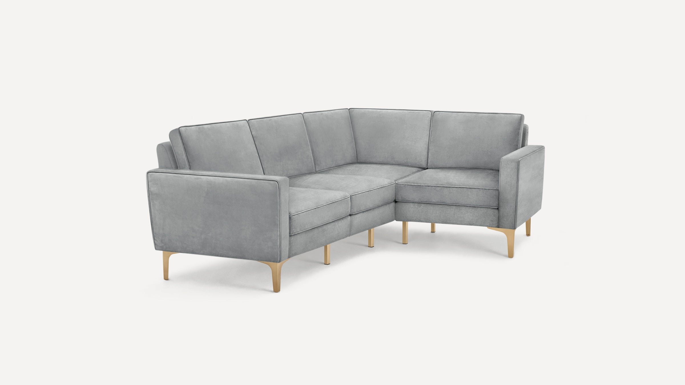 Light gray velvet L-shaped sectional sofa with slim gold metal legs and clean, modern design.