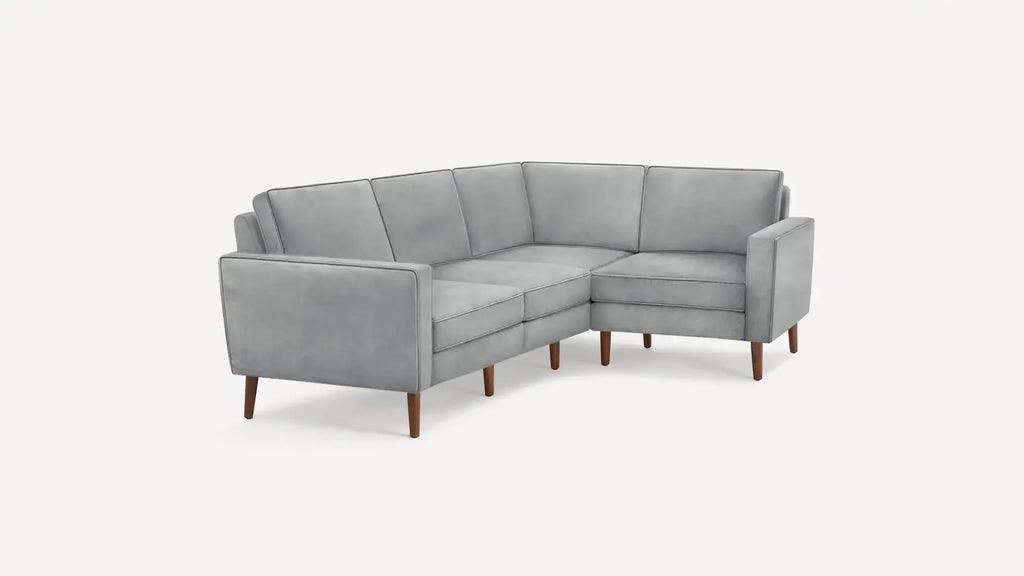 modern l - shaped sectional sofa with light gray fabric upholstery and wooden legs, featuring a clean, minimalist design