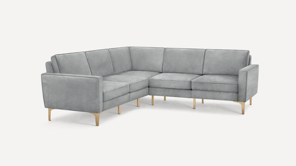 Light grey L-shaped sectional sofa with clean lines, plush cushions, and gold metal legs on a white background.