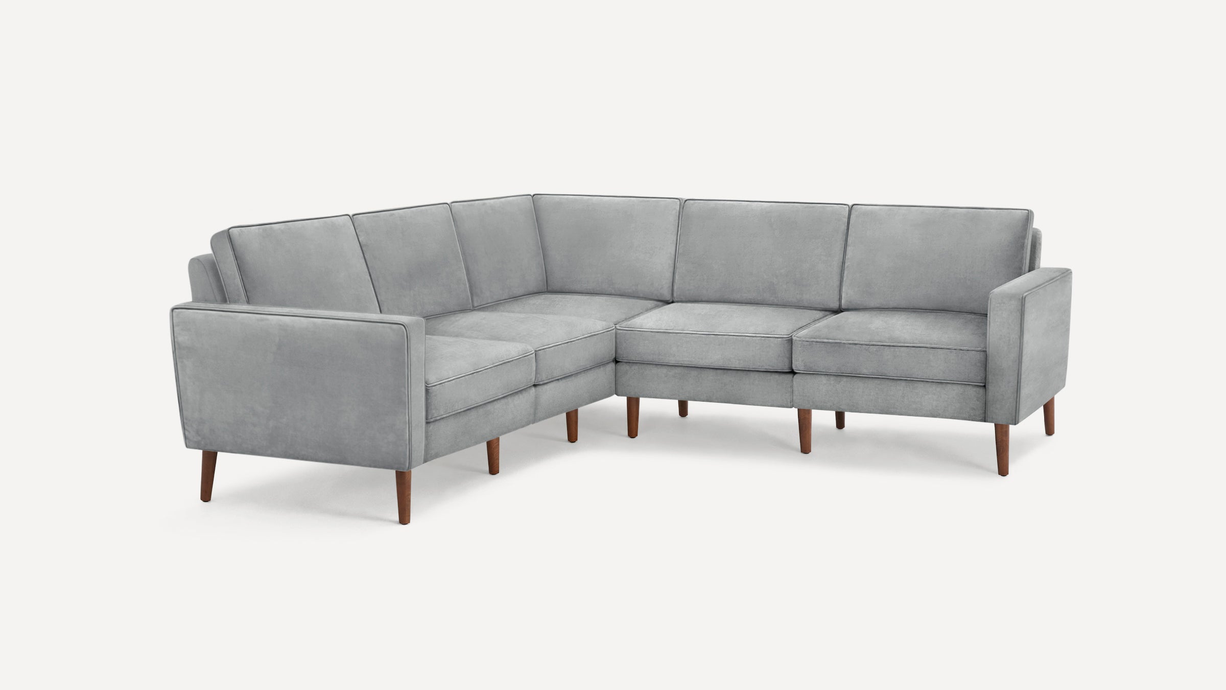 Light gray L-shaped sectional sofa with clean lines, cushioned seats, and wooden tapered legs on a white background.
