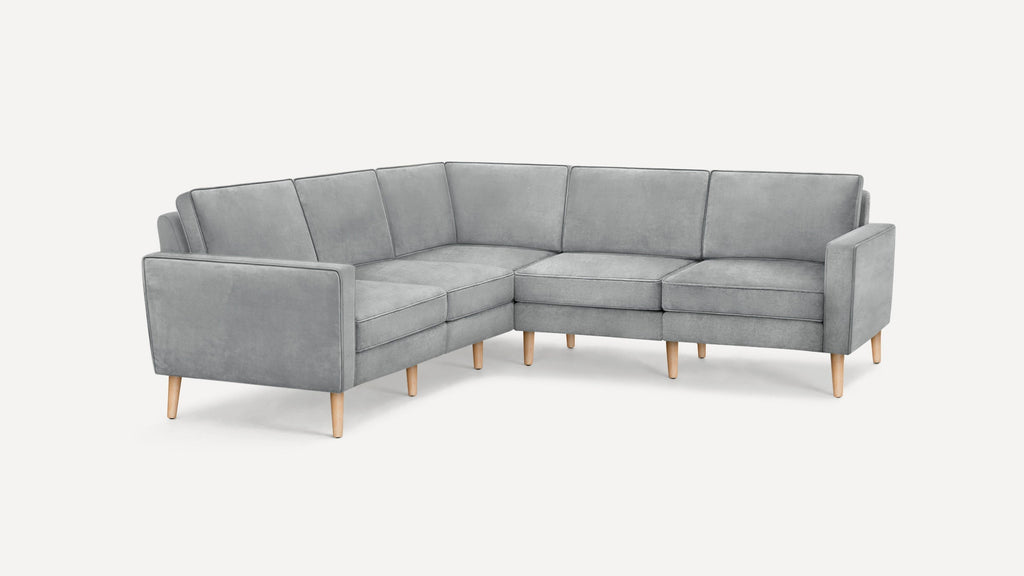 Light gray fabric sectional sofa with clean lines, wooden legs, and a modern minimalist design.