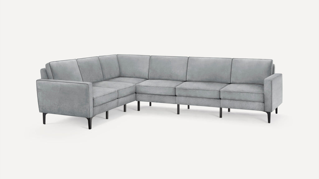 Modern L-shaped sectional sofa in light gray fabric with clean lines, slim black legs, and cushioned seats and backs.