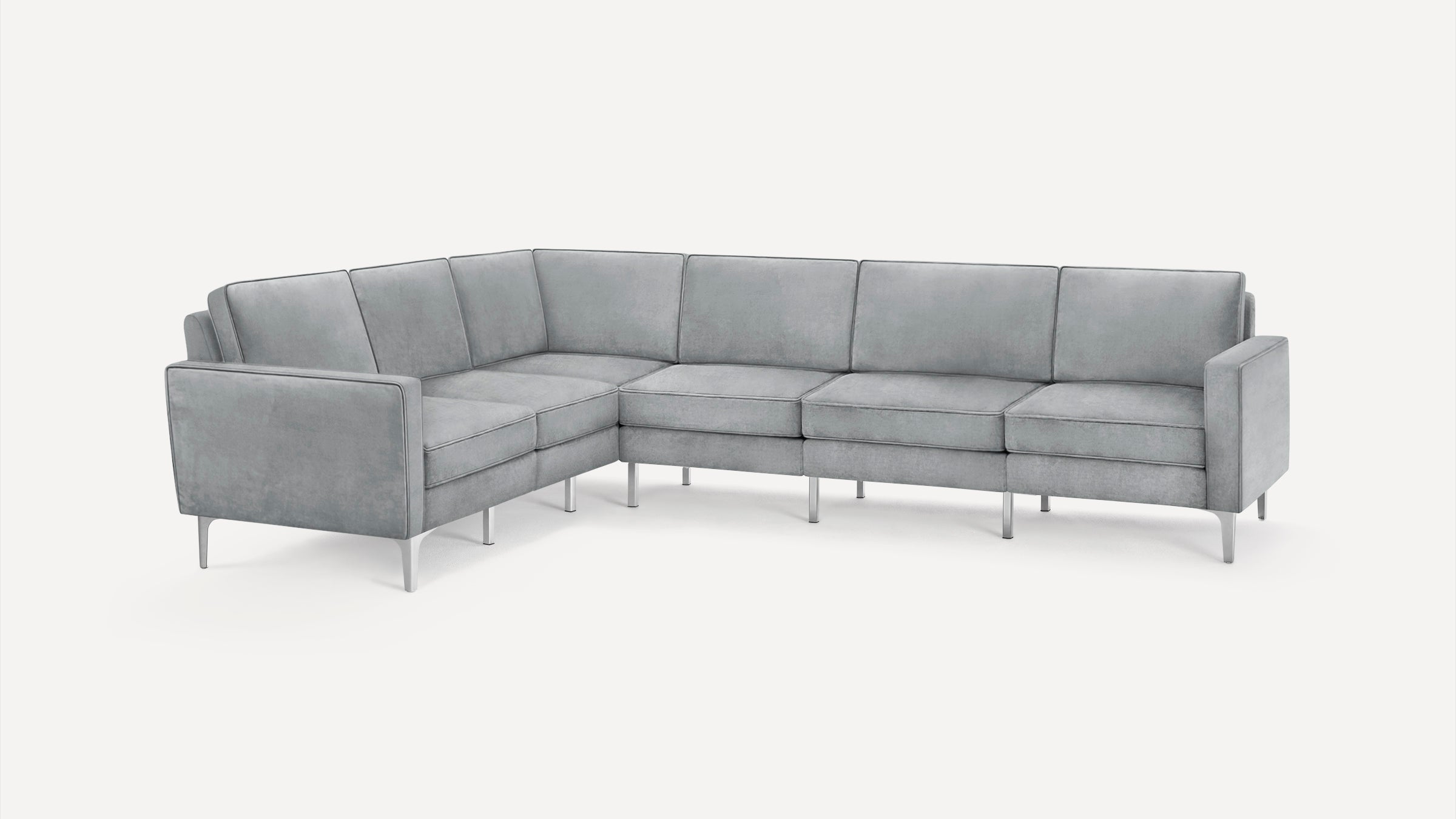 Modern L-shaped sectional sofa with light gray upholstery and sleek metal legs, featuring clean lines and firm cushions.