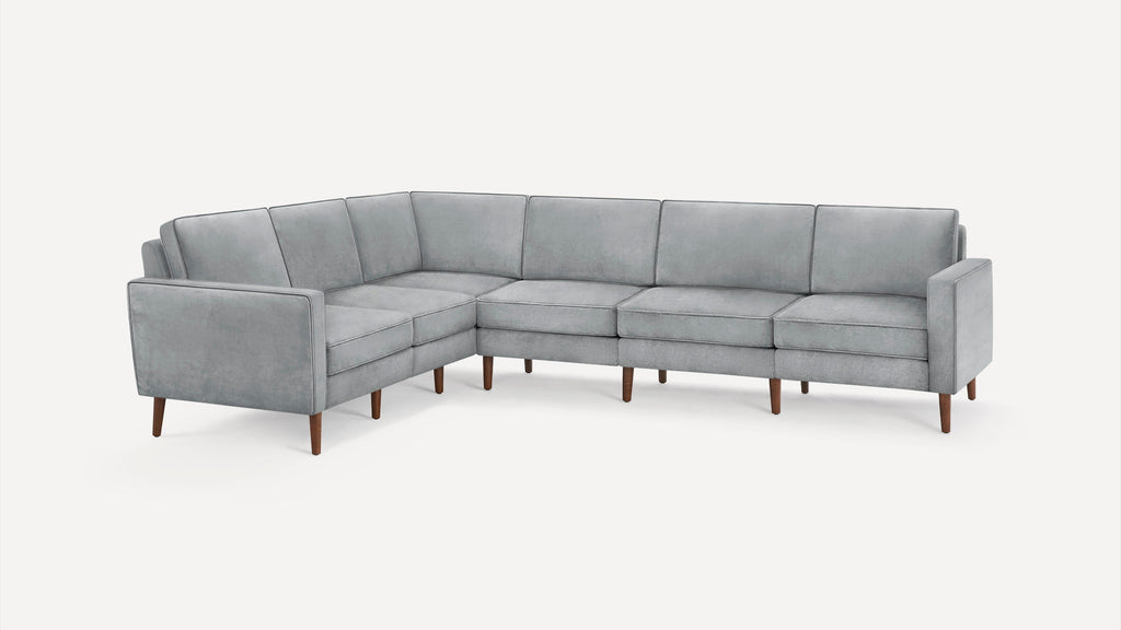 Modern L-shaped sectional sofa in light gray fabric with clean lines and wooden tapered legs on a white background.