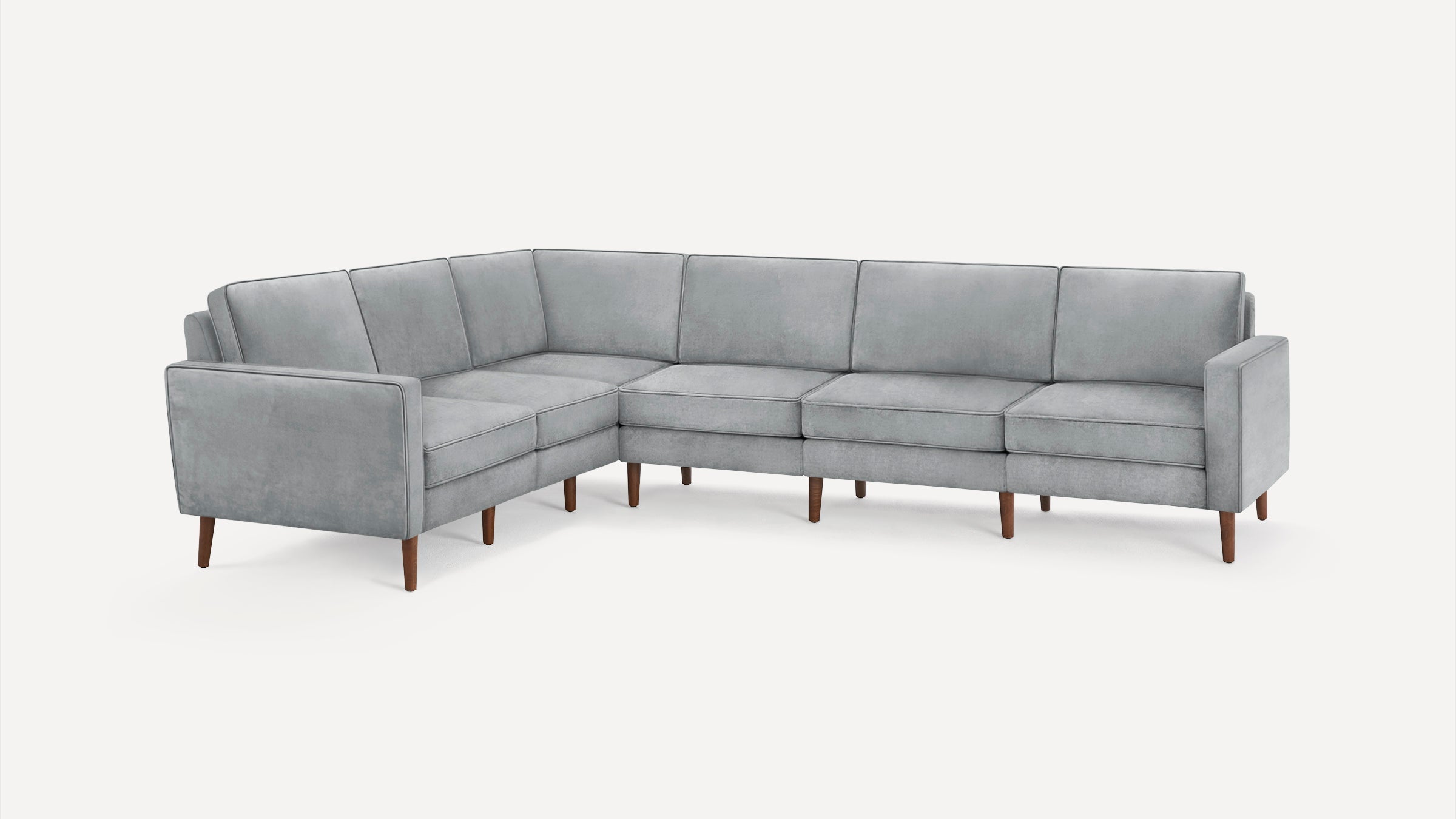 Modern L-shaped sectional sofa in light gray fabric with clean lines and wooden tapered legs on a white background.