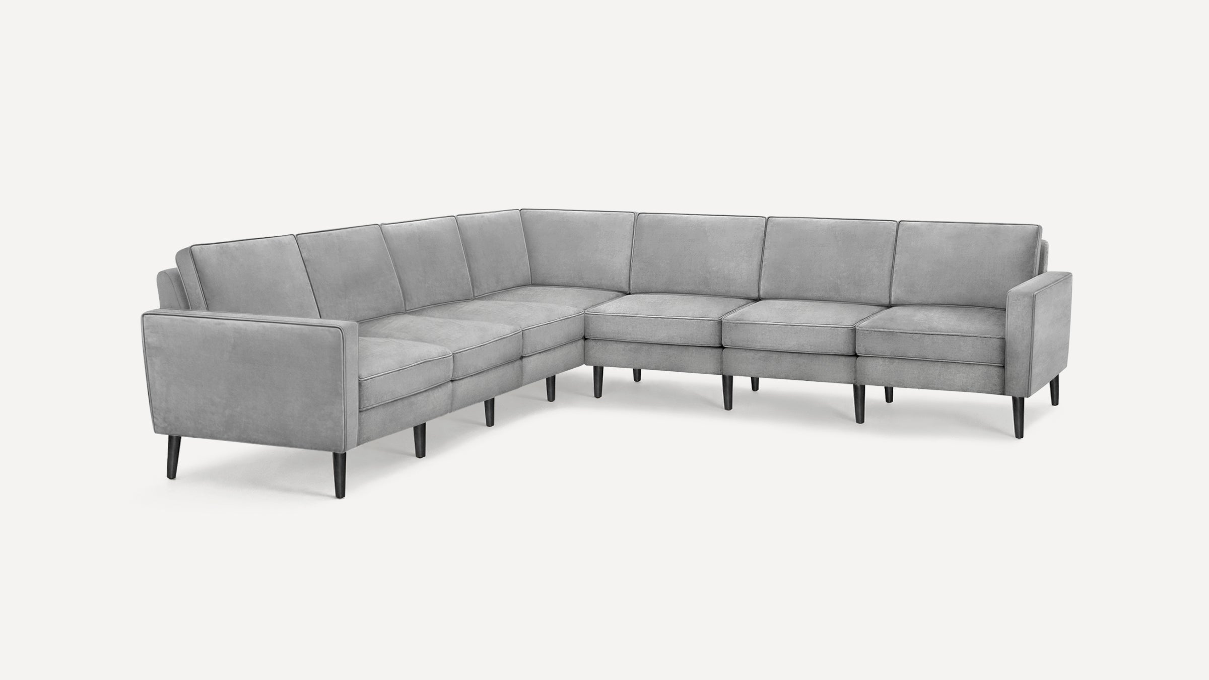L-shaped gray sectional sofa with tufted cushions, slim black legs, and clean, modern design on a white background.