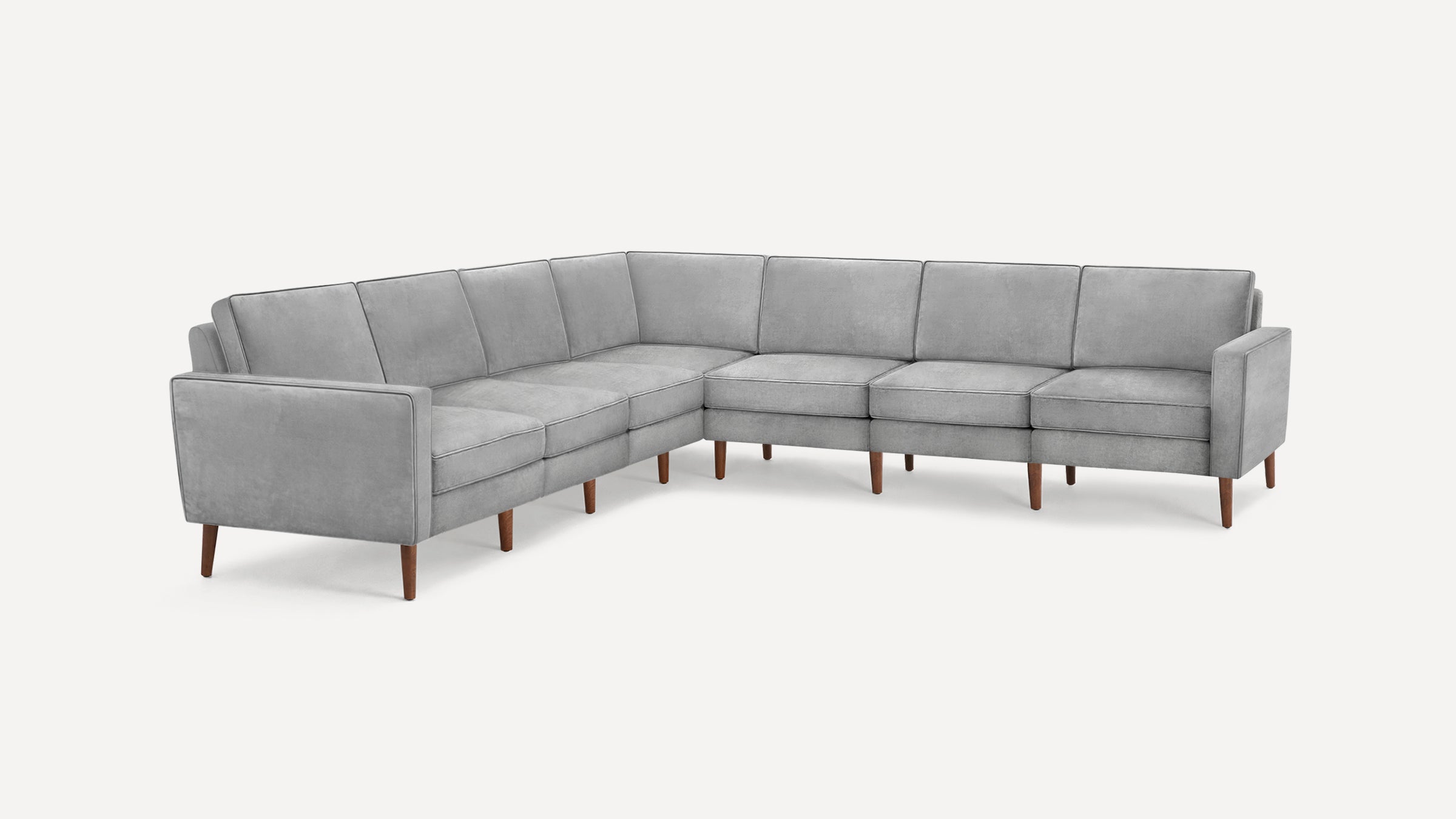 Modern L-shaped sectional sofa in light gray upholstery with clean lines and wooden tapered legs on a white background.