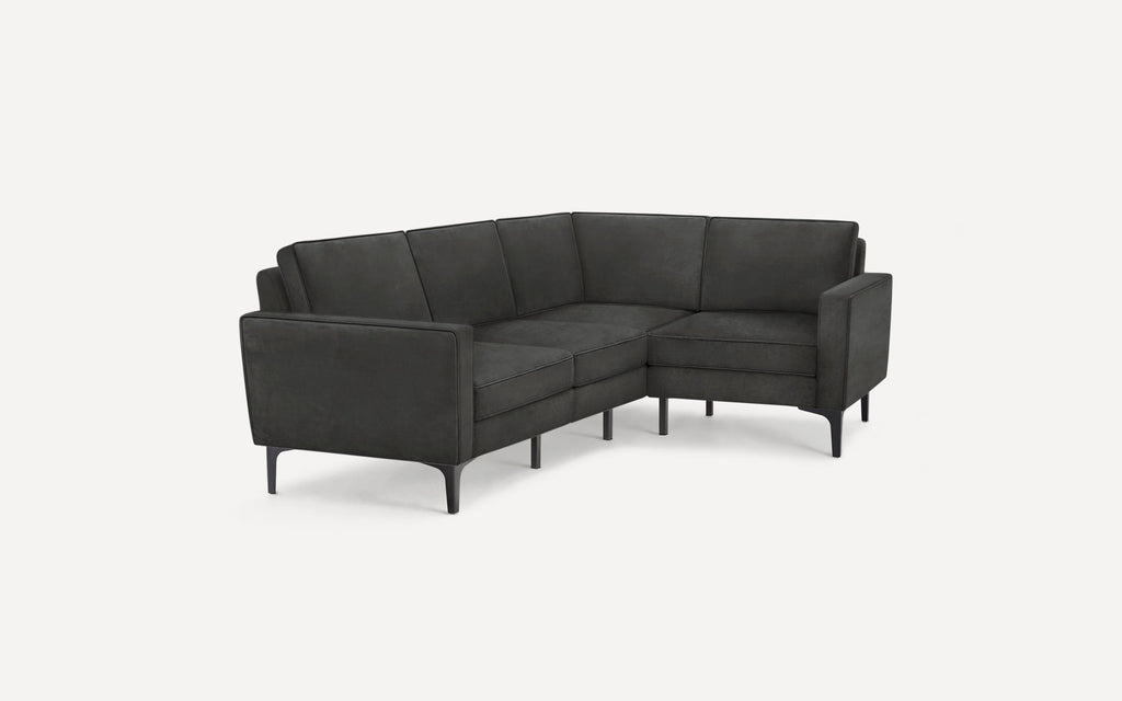 Modern dark gray L-shaped sectional sofa with sleek armrests and angled black legs, designed for a contemporary living space.