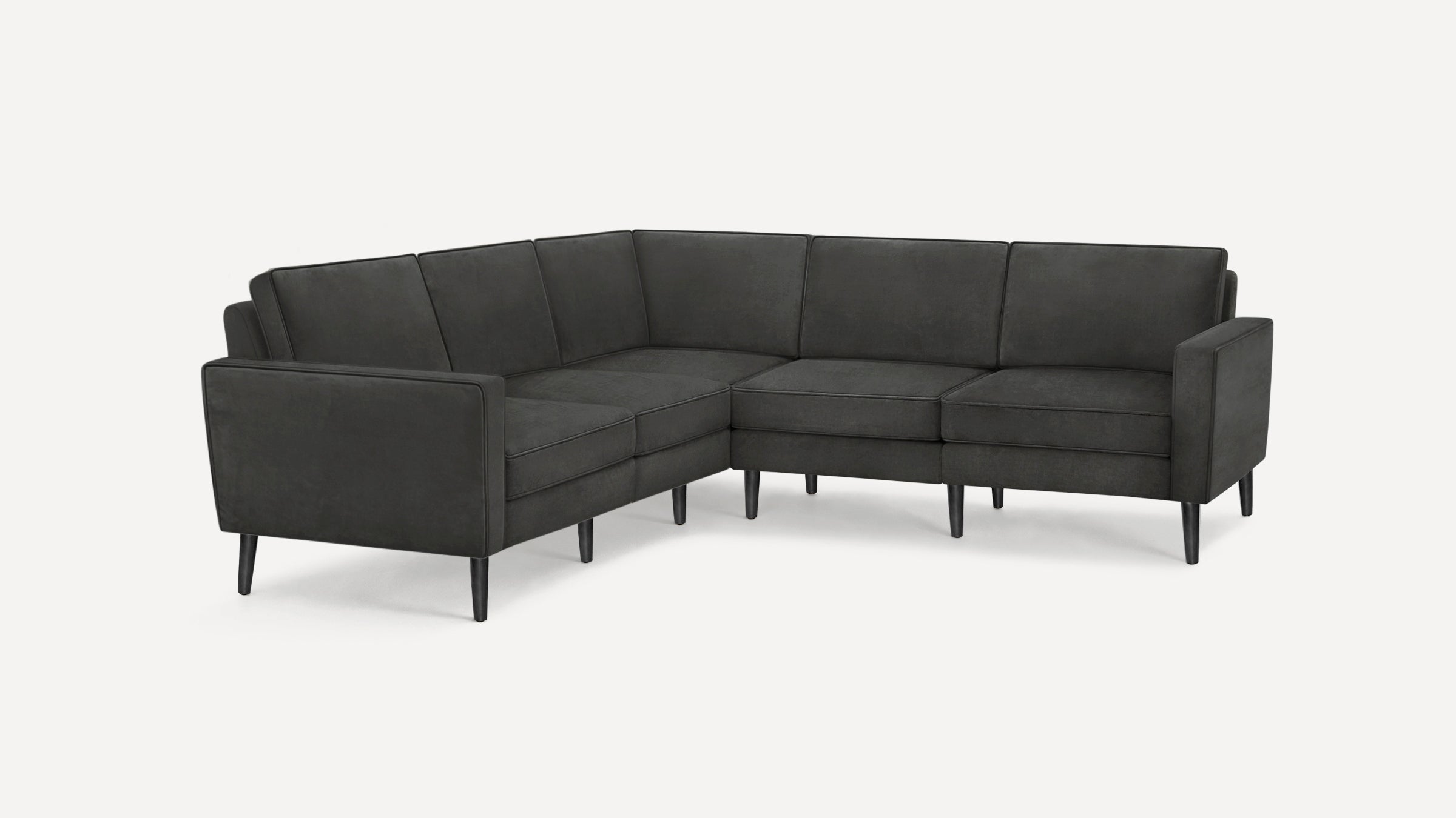 Dark gray upholstered modern L-shaped sectional sofa with slim black legs and clean lines on white background.