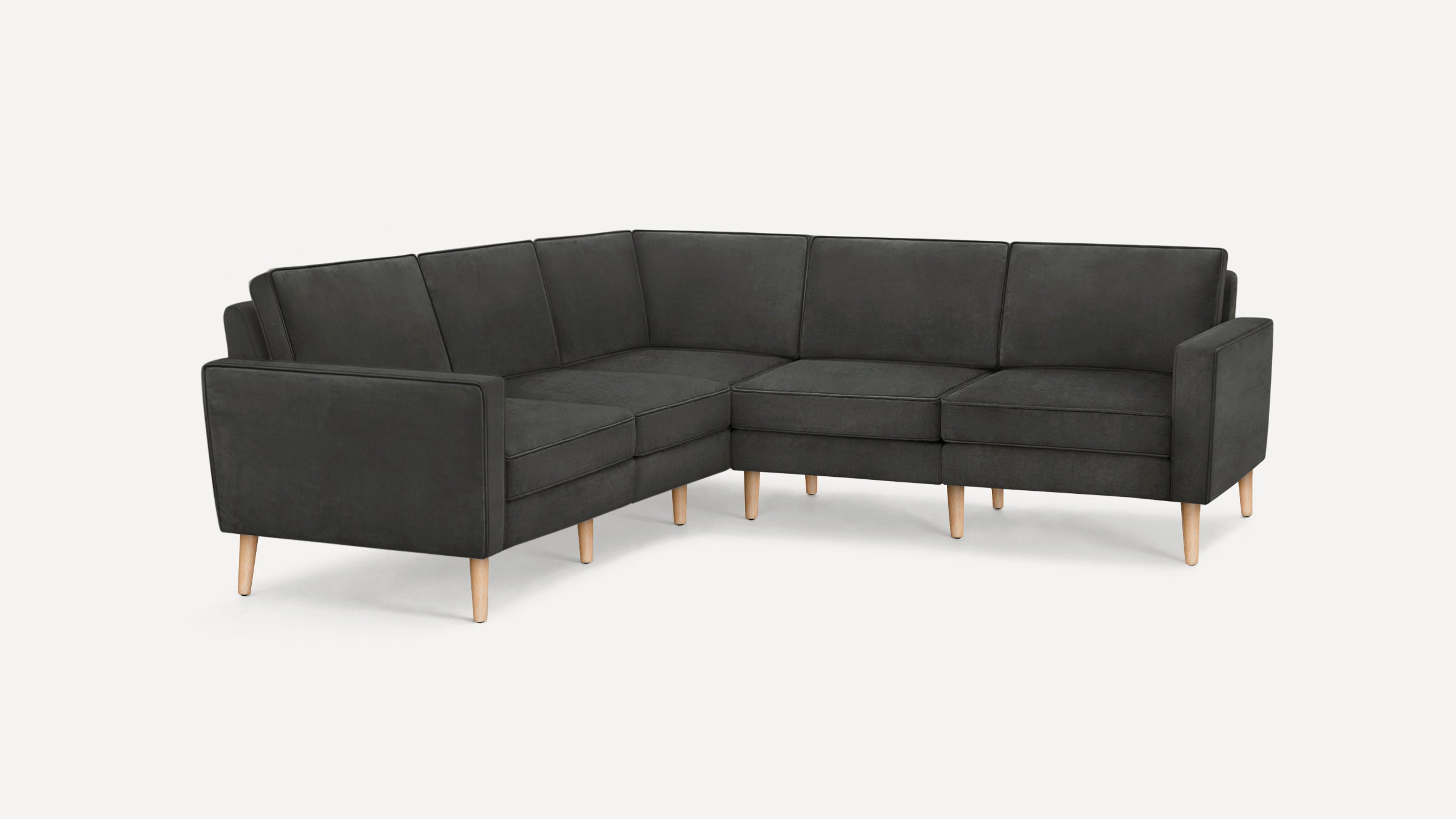 Modern L-shaped dark gray sectional sofa with clean lines, plush cushions, and light wooden tapered legs on a white background.