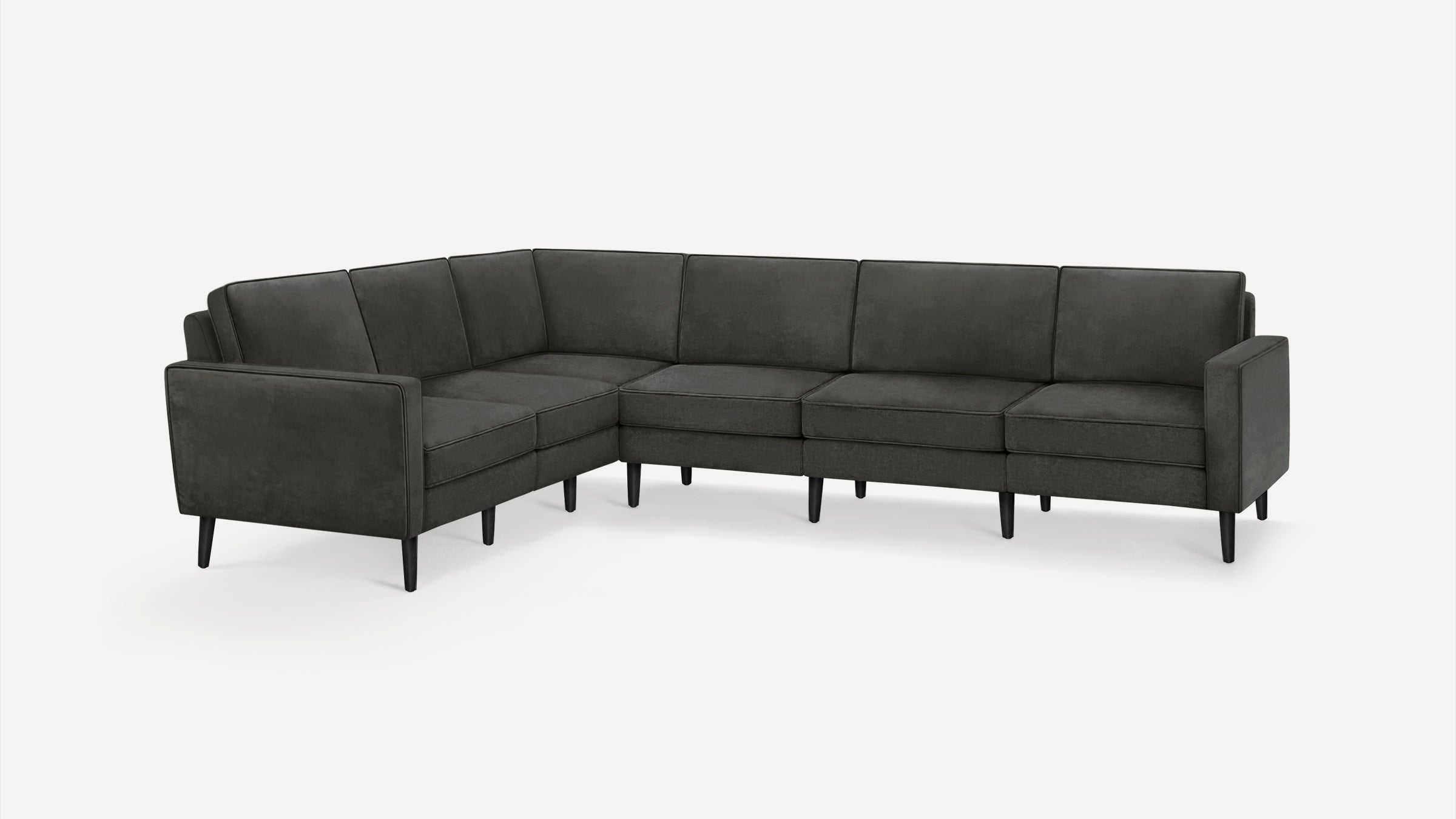 Modern dark grey L-shaped sectional sofa with slim black legs, cushioned seats, and backrests on a white background.