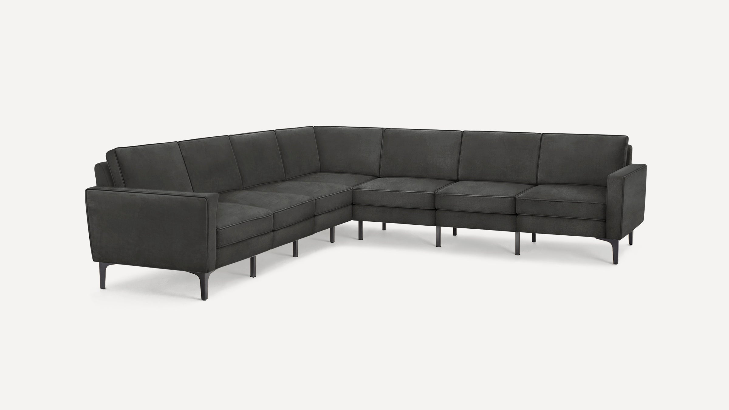 Modern dark gray L-shaped sectional sofa with clean lines, thin metal legs, and plush cushions in a minimalist style.