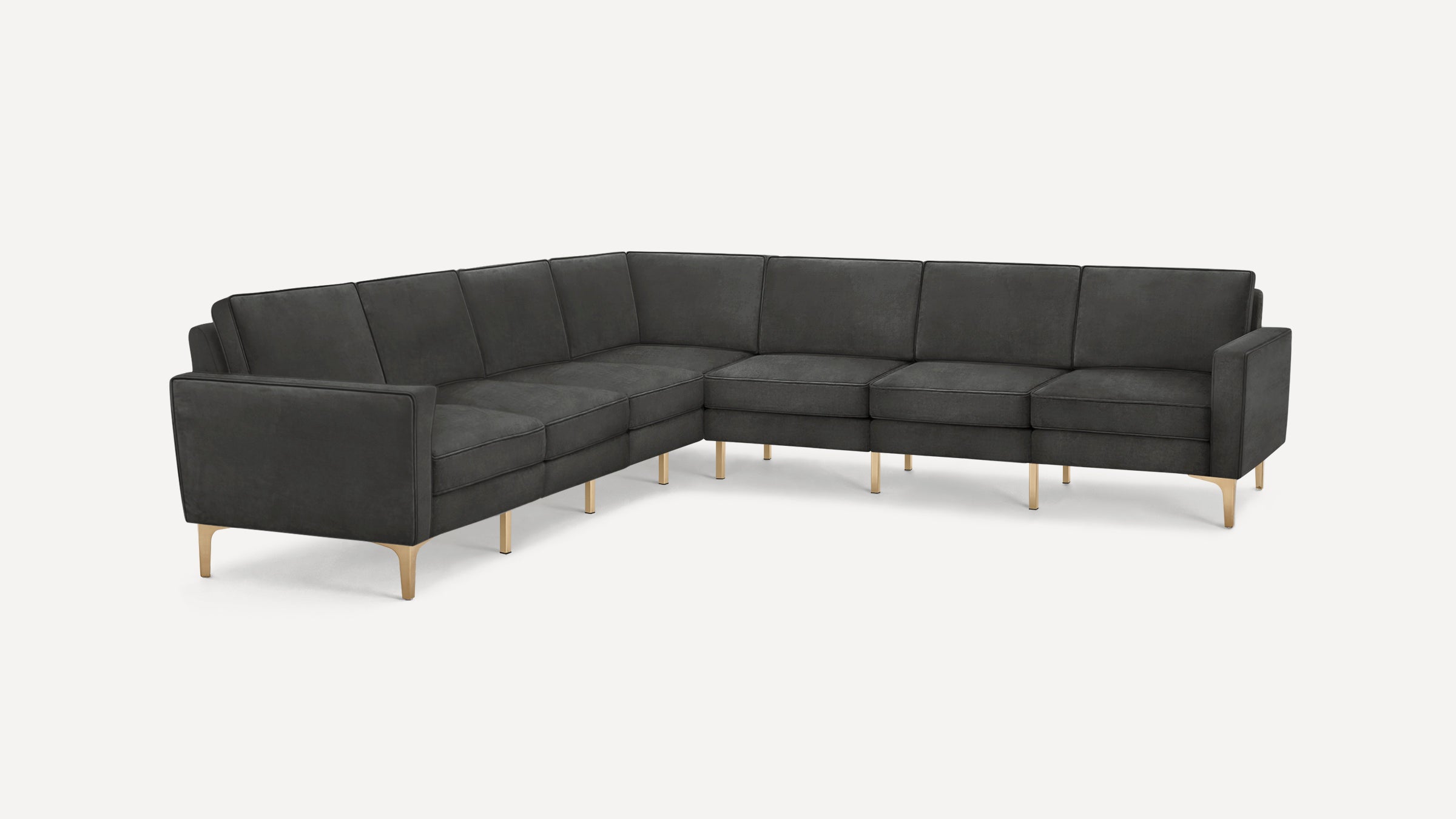 Dark gray L-shaped sectional sofa with clean lines, tufted cushions, and light wooden legs against a plain white background.