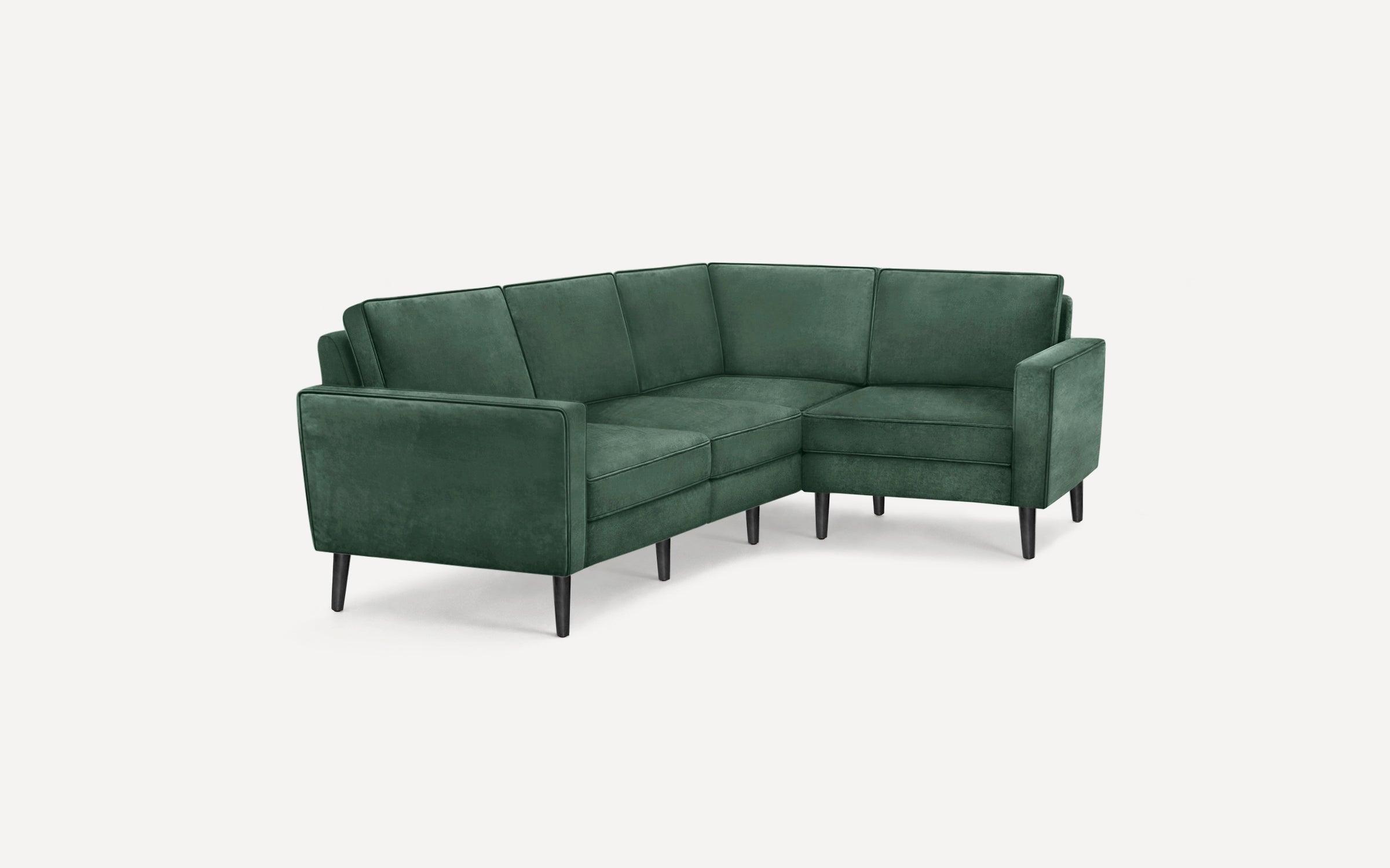Modern L-shaped sectional sofa in dark green velvet upholstery with sleek black tapered legs.