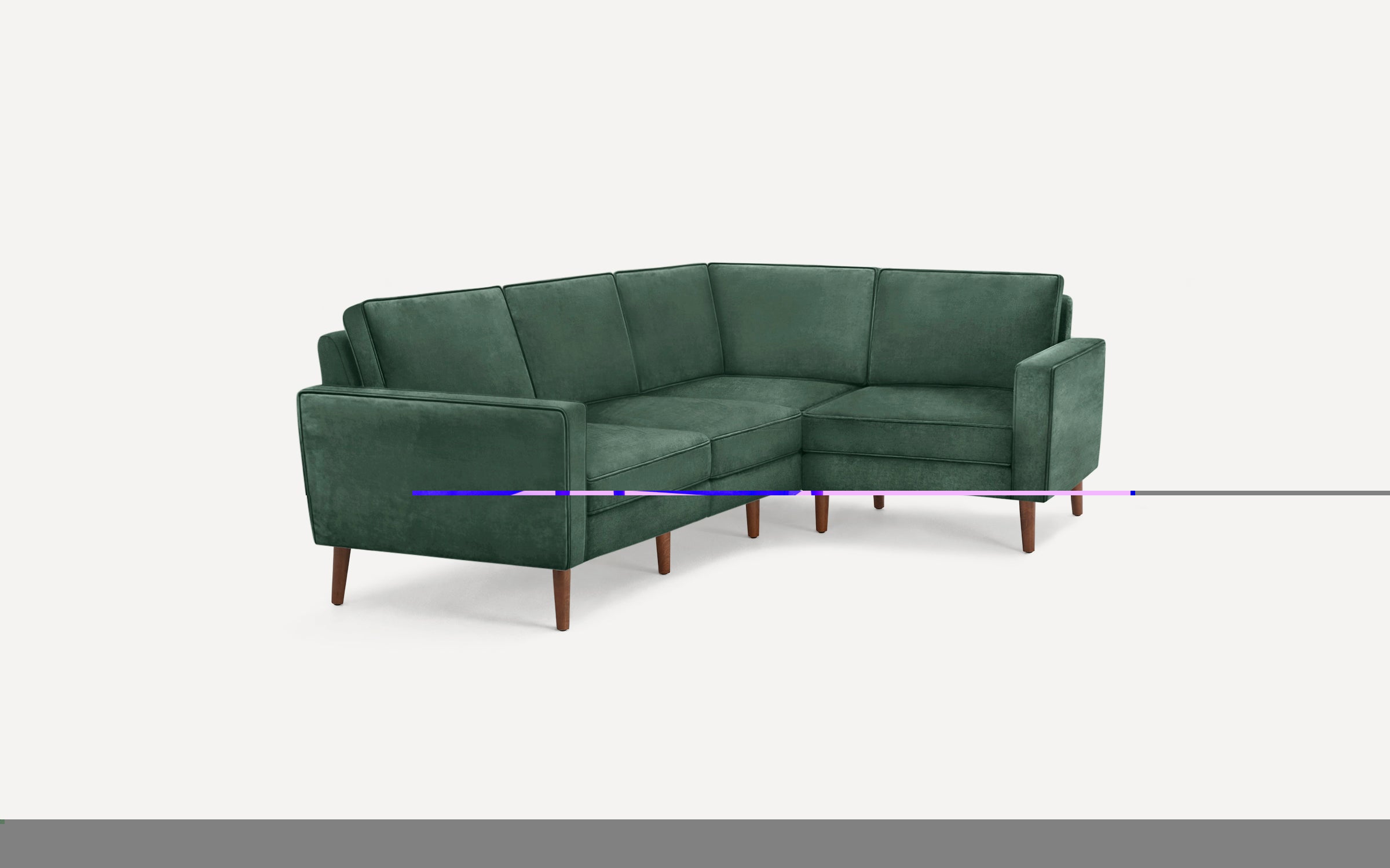 Green velvet L-shaped sectional sofa with wooden tapered legs and clean, modern lines on a white background.