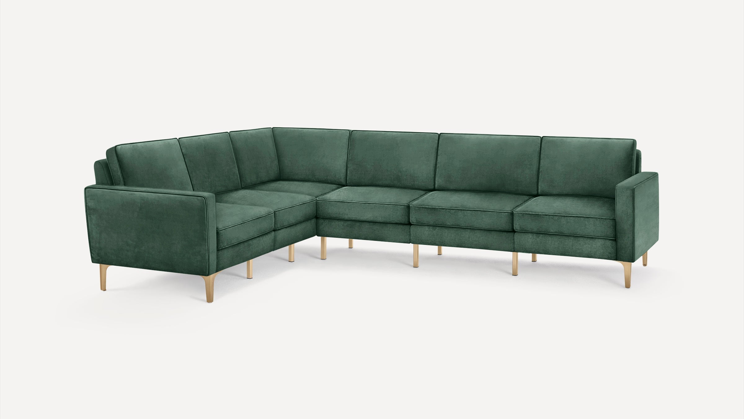 L-shaped sectional sofa upholstered in dark green fabric with slim wooden legs and clean, modern lines.