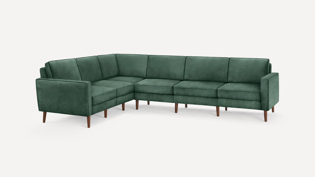 Green velvet L-shaped sectional sofa with wooden legs and modern, clean-lined design on white background.