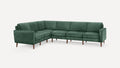 Green velvet L-shaped sectional sofa with wooden legs and modern, clean-lined design on white background.