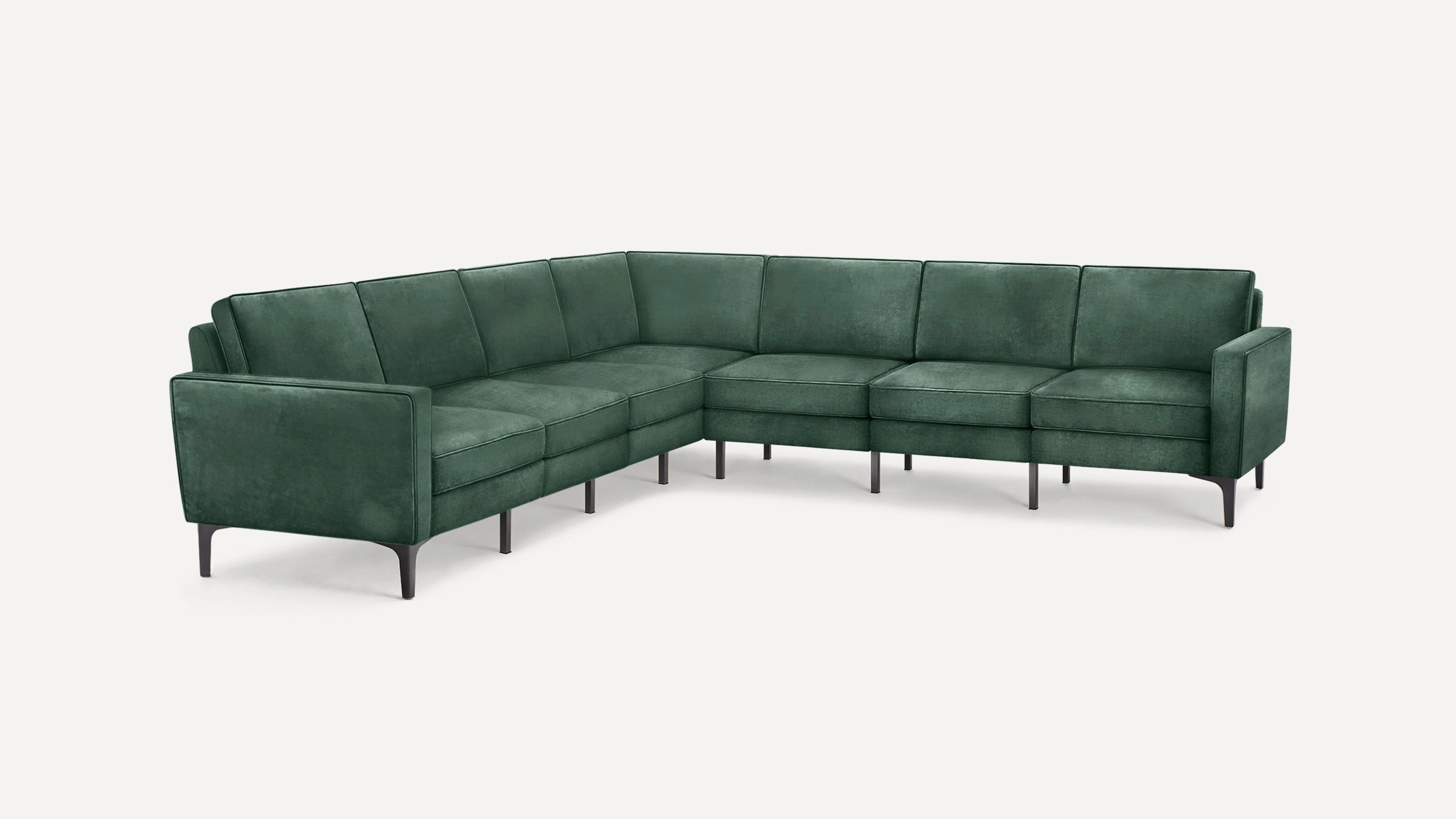 Modern L-shaped sectional sofa upholstered in dark green fabric with slim black legs and clean, straight armrests.