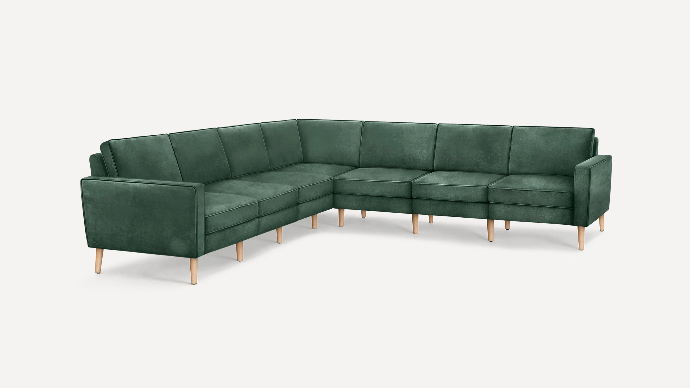 L-shaped sectional sofa with dark green velvet upholstery and light wooden legs, featuring clean lines and modern design.