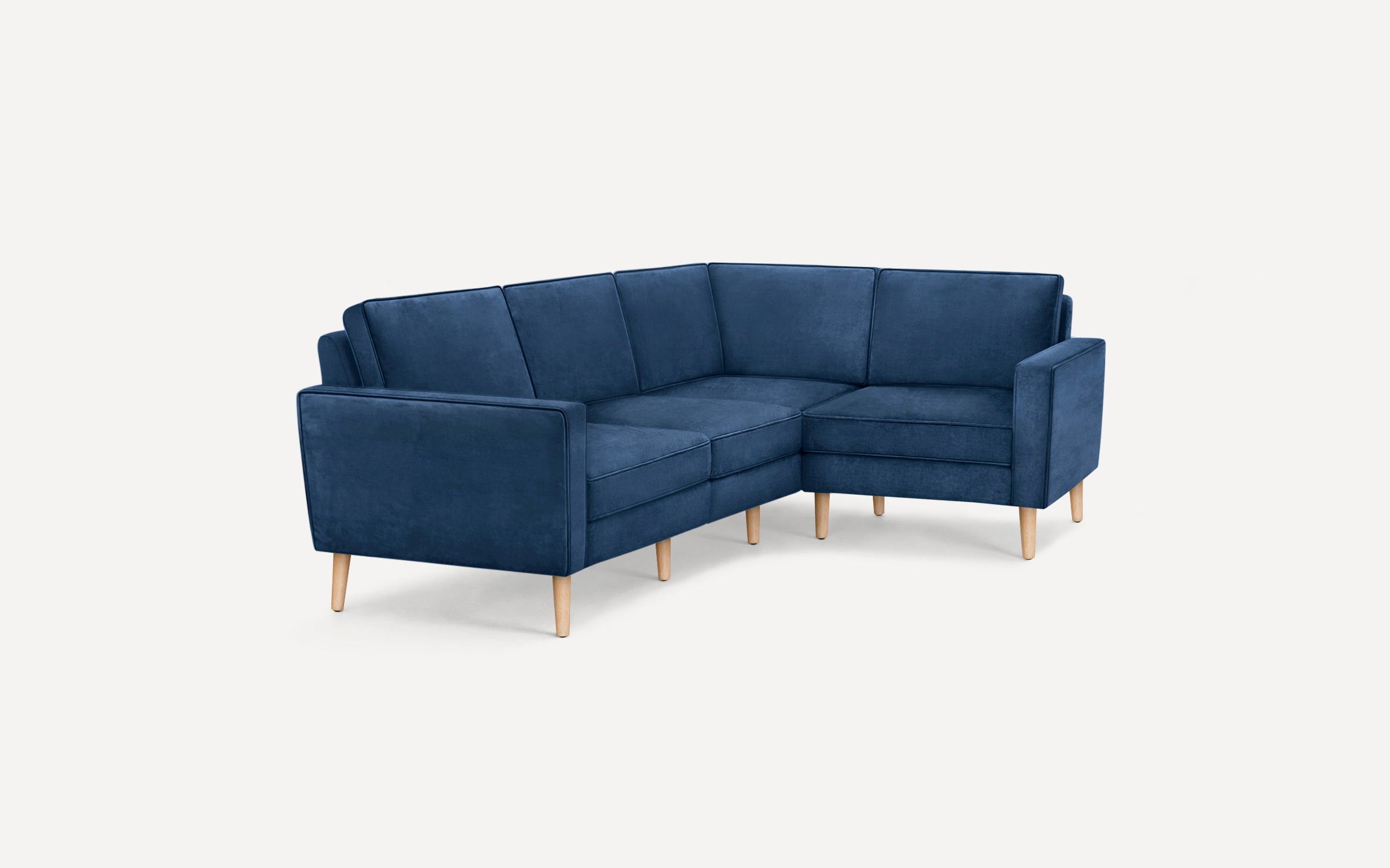 Corner sectional sofa with deep blue upholstery, clean lines, and light wooden tapered legs on a plain white background.