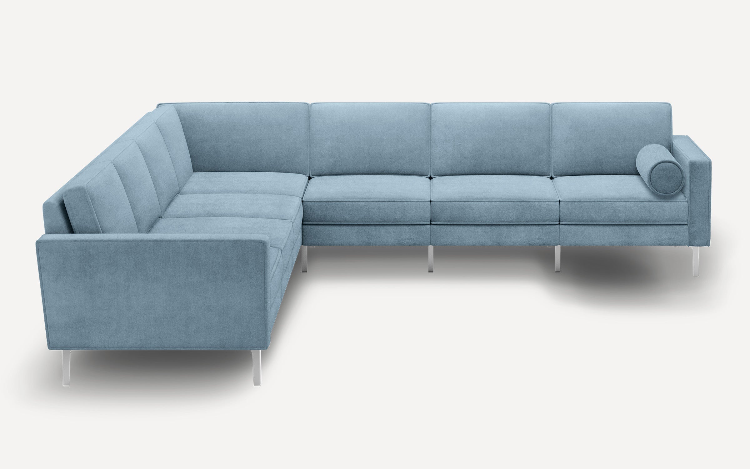 Light blue L-shaped sectional sofa with modern design, plush cushions, slim metal legs, and a cylindrical bolster pillow on one end.