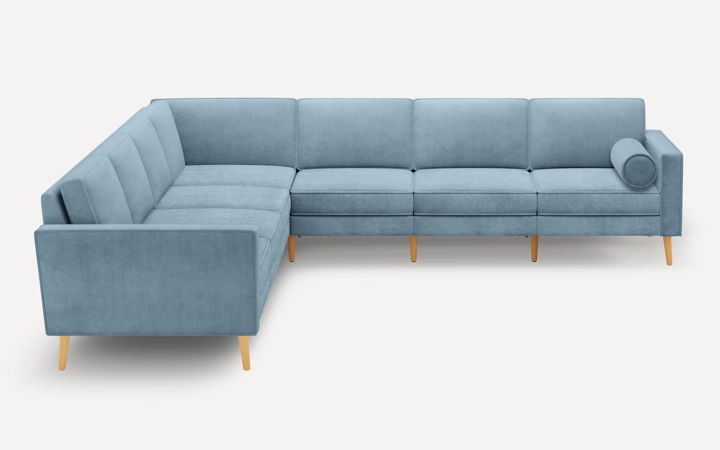 Light blue L-shaped sectional sofa with wooden legs and a round bolster pillow on one end, shown against a white background.