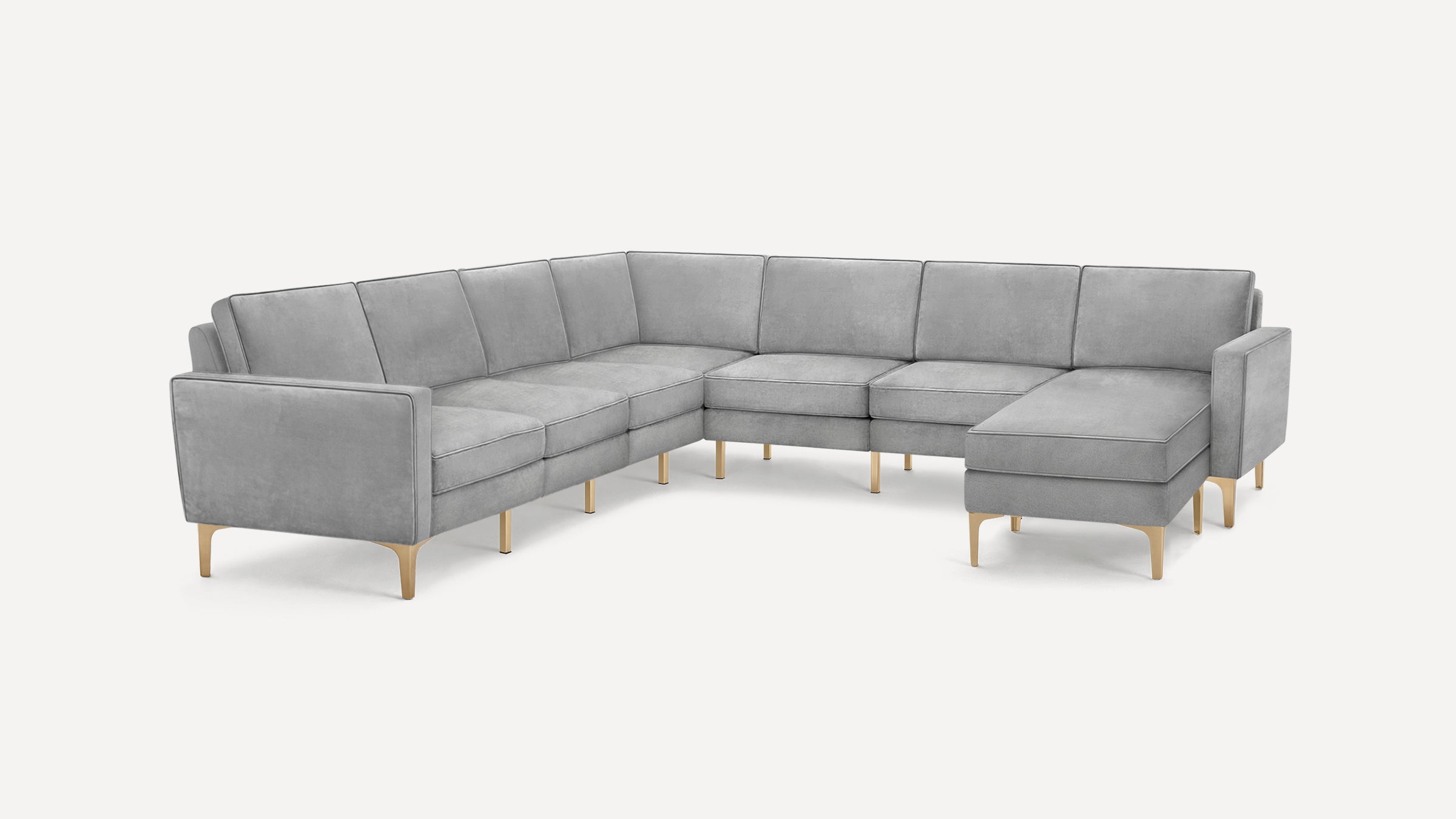 Large modern L-shaped sectional sofa in light gray fabric with sleek gold metal legs and clean lines.