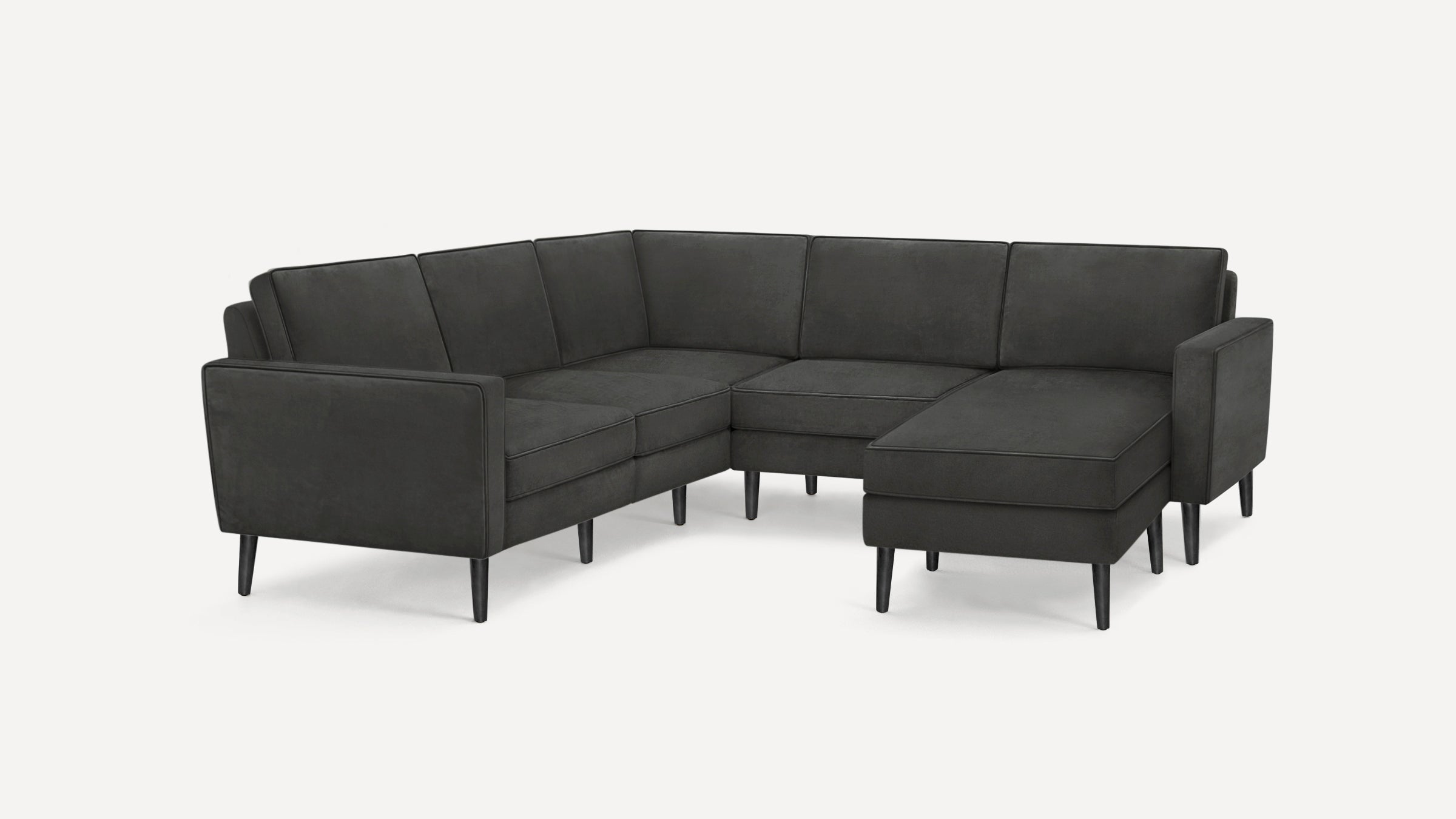Modern dark gray sectional sofa with clean lines, high tapered legs, and cushioned seats and backrests in L-shaped configuration.