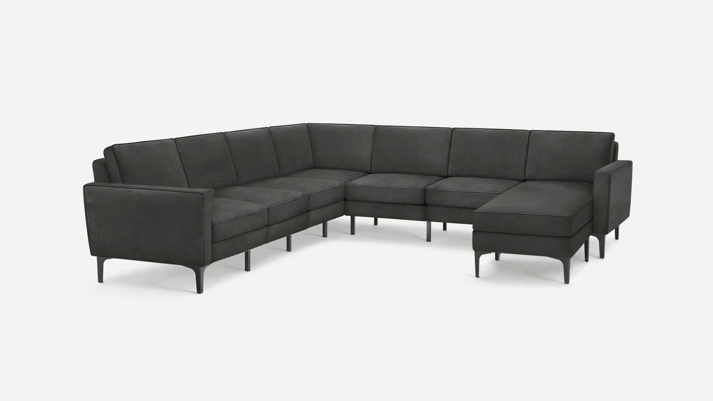 Dark gray modern sectional sofa with clean lines, slim metal legs, and a chaise lounge on the right side.