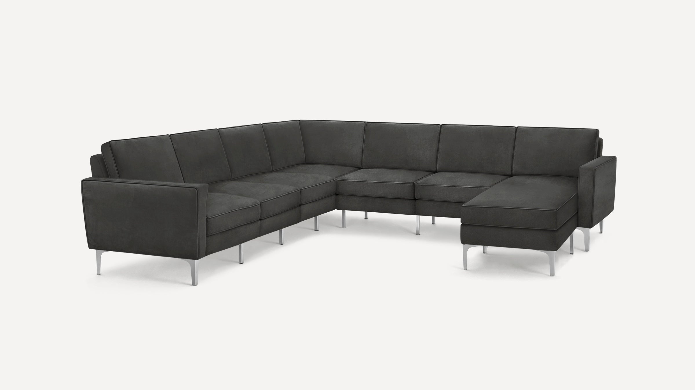 Dark gray modern L-shaped sectional sofa with metal legs and plush cushions on a white background.