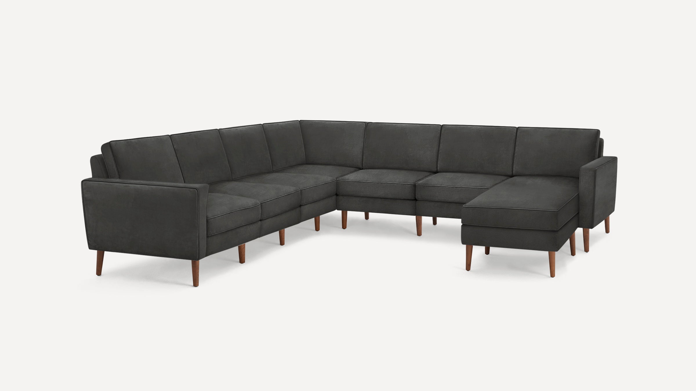 Modern dark gray sectional sofa with wooden legs, featuring a left armrest and a right chaise lounge for spacious seating.