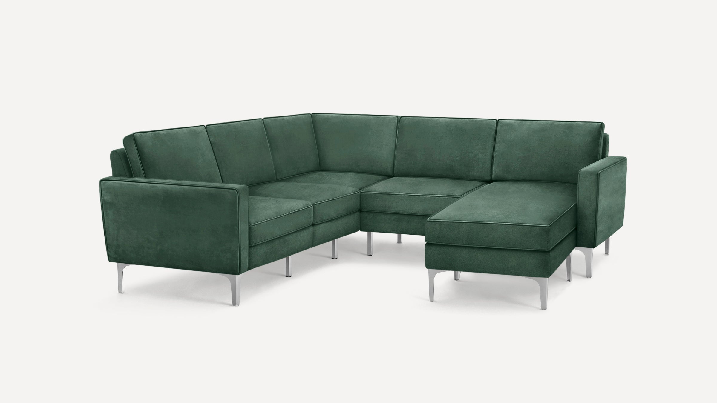 Modern L-shaped sectional sofa in dark green velvet upholstery with sleek silver metal legs and clean lines.