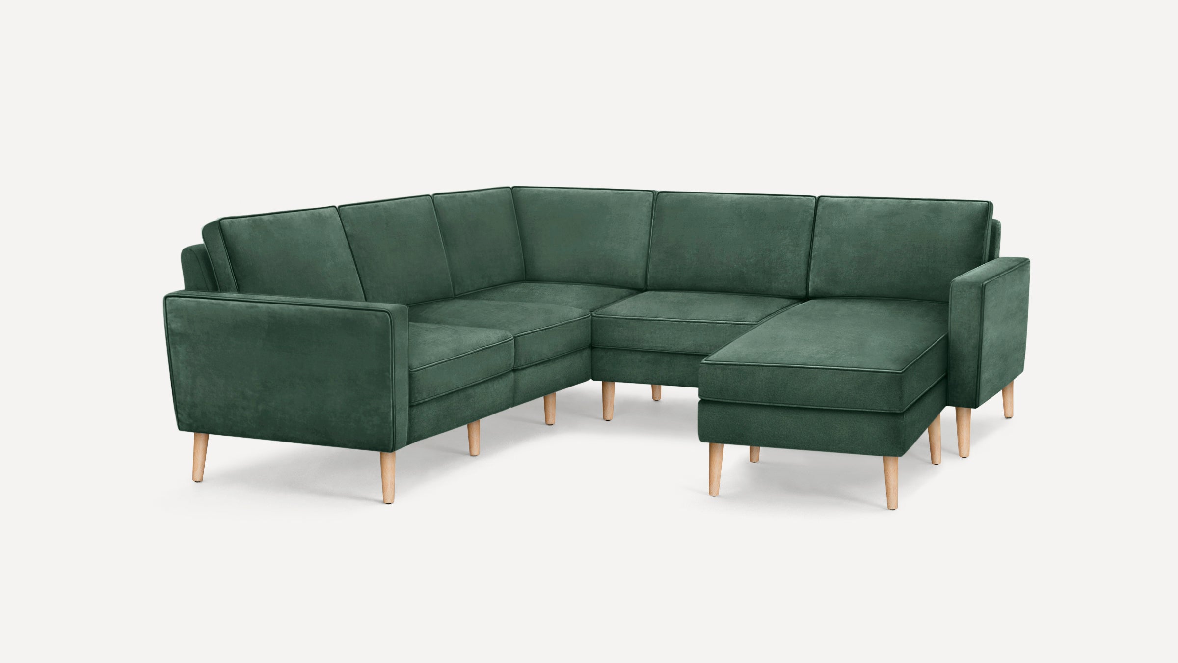 Green velvet upholstered sectional sofa with wooden legs, featuring a right-side chaise and clean, modern design.