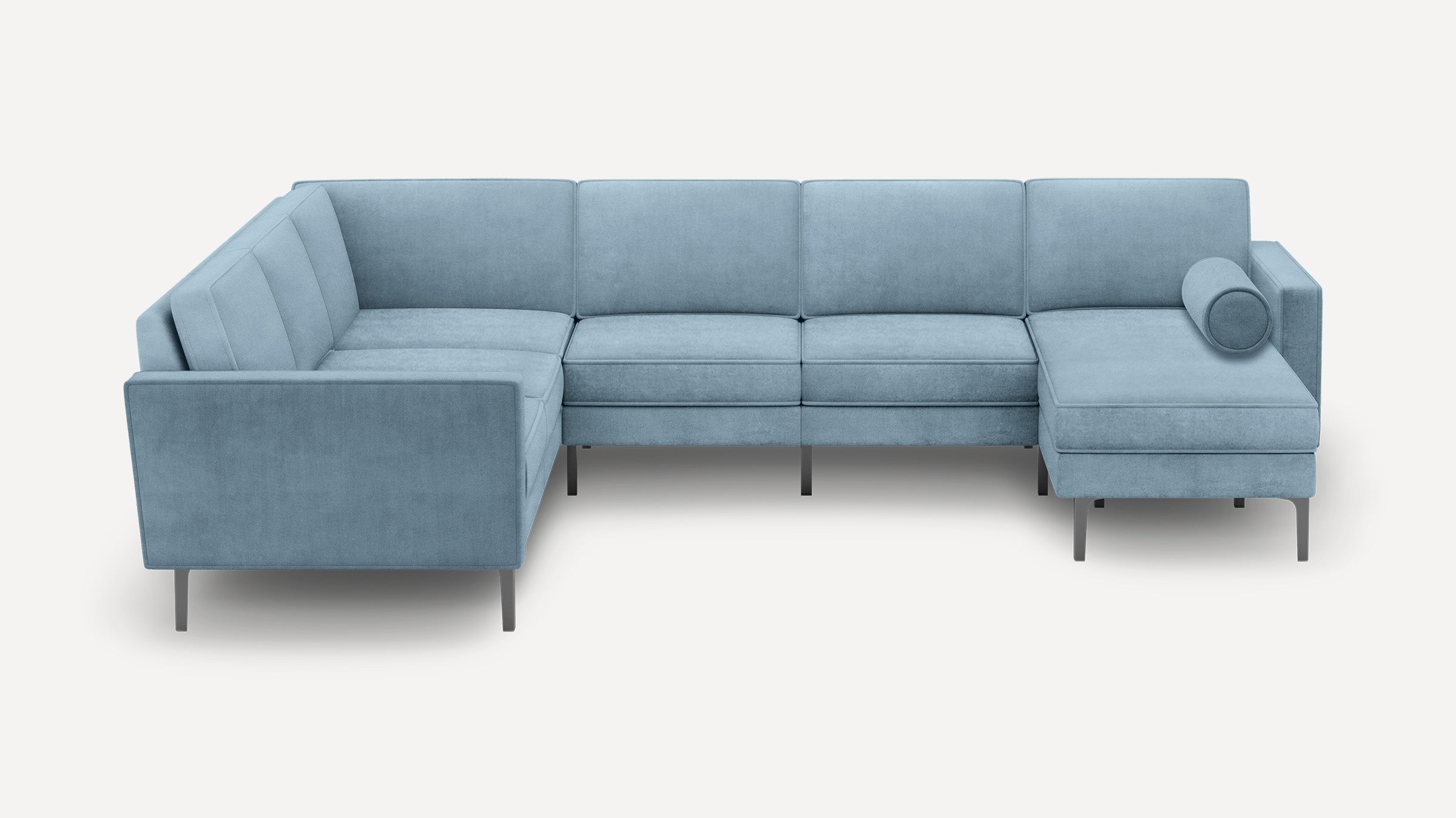 Light blue modern L-shaped sectional sofa with slim metal legs and a round bolster pillow on chaise end.