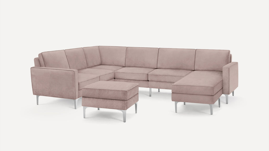 Light mauve-colored modern sectional sofa with silver metal legs and matching ottoman on a white background.