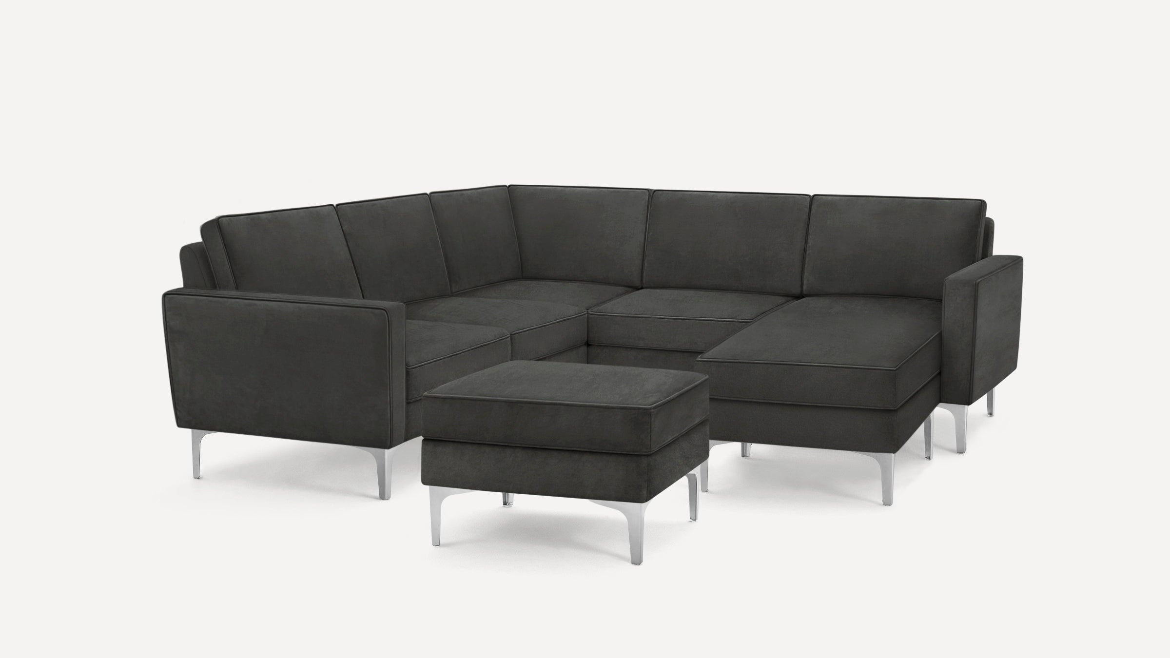 Dark gray modern sectional sofa with a matching ottoman, featuring sleek metal legs and clean-lined cushions.