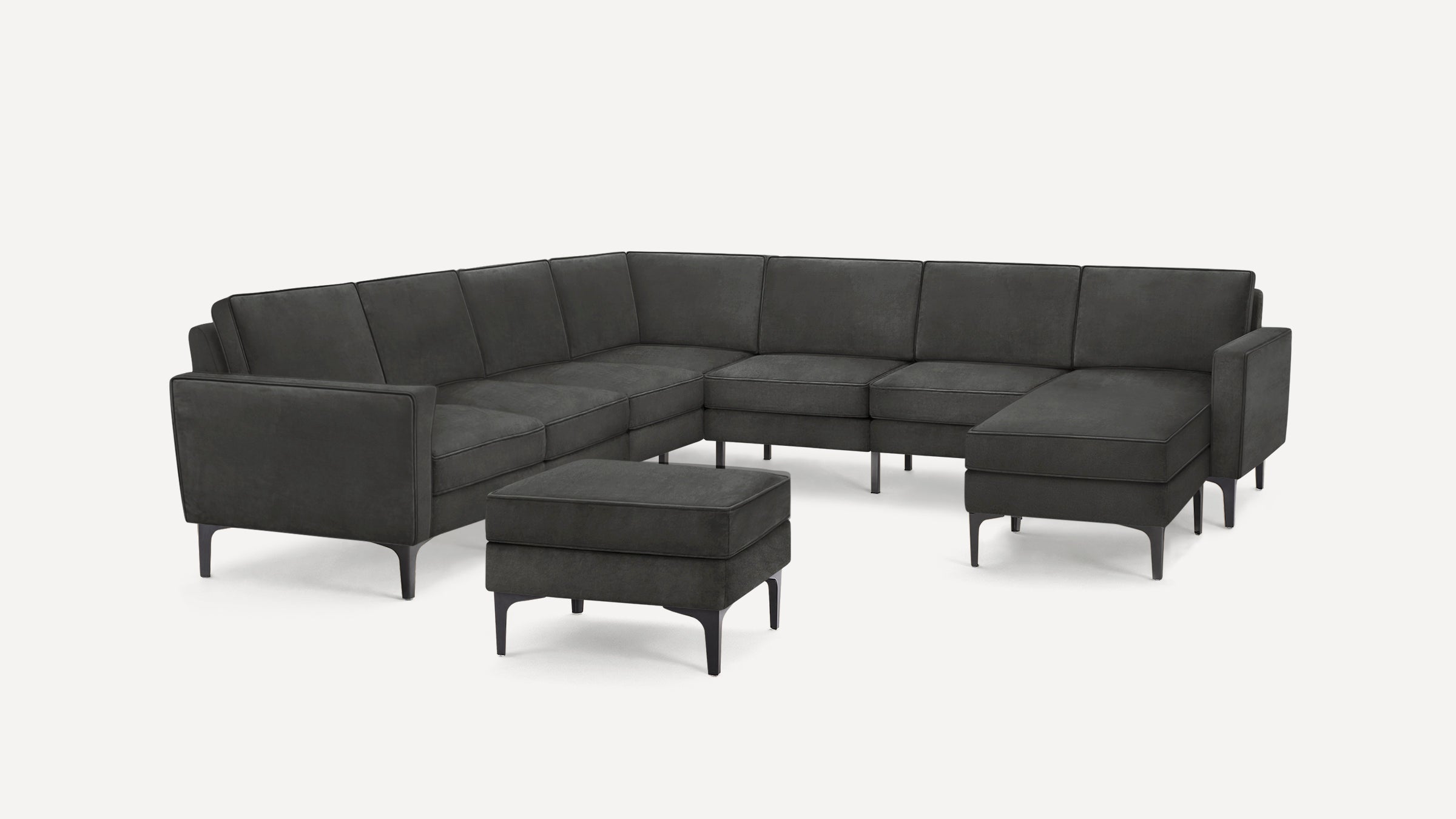 Modern dark gray sectional sofa with clean lines, metal legs, and matching ottoman, set against white background.