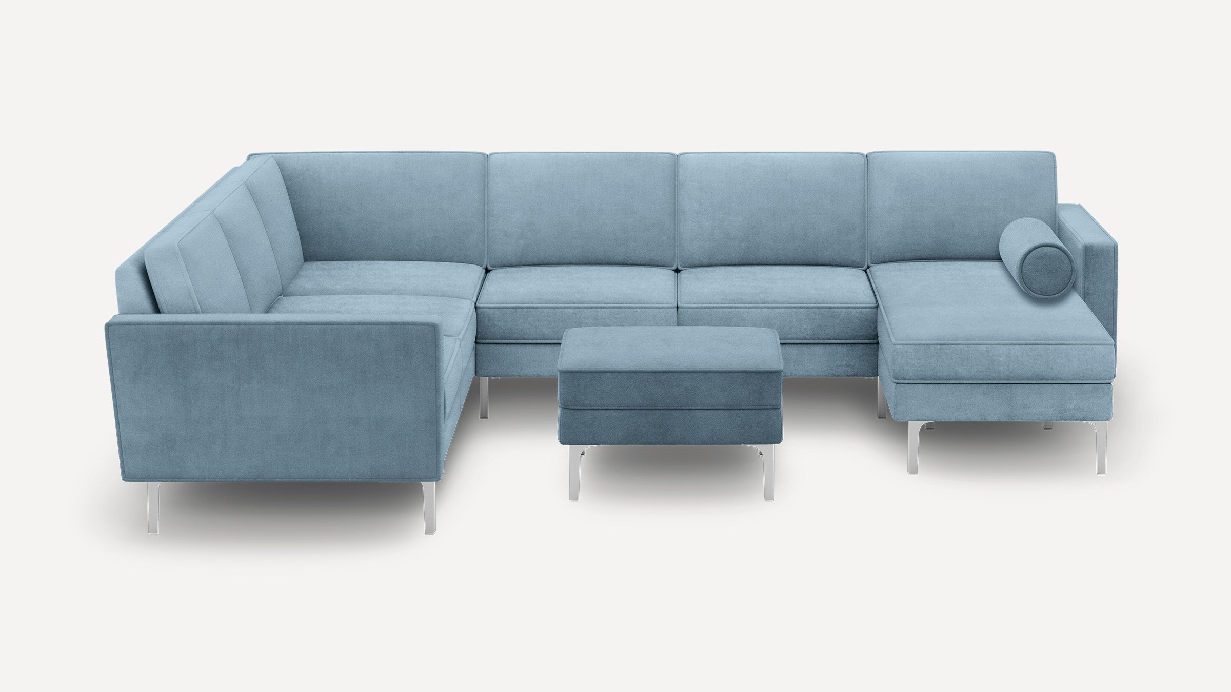 Light blue modern sectional sofa with an ottoman, featuring clean lines, tufted cushions, and metal legs.
