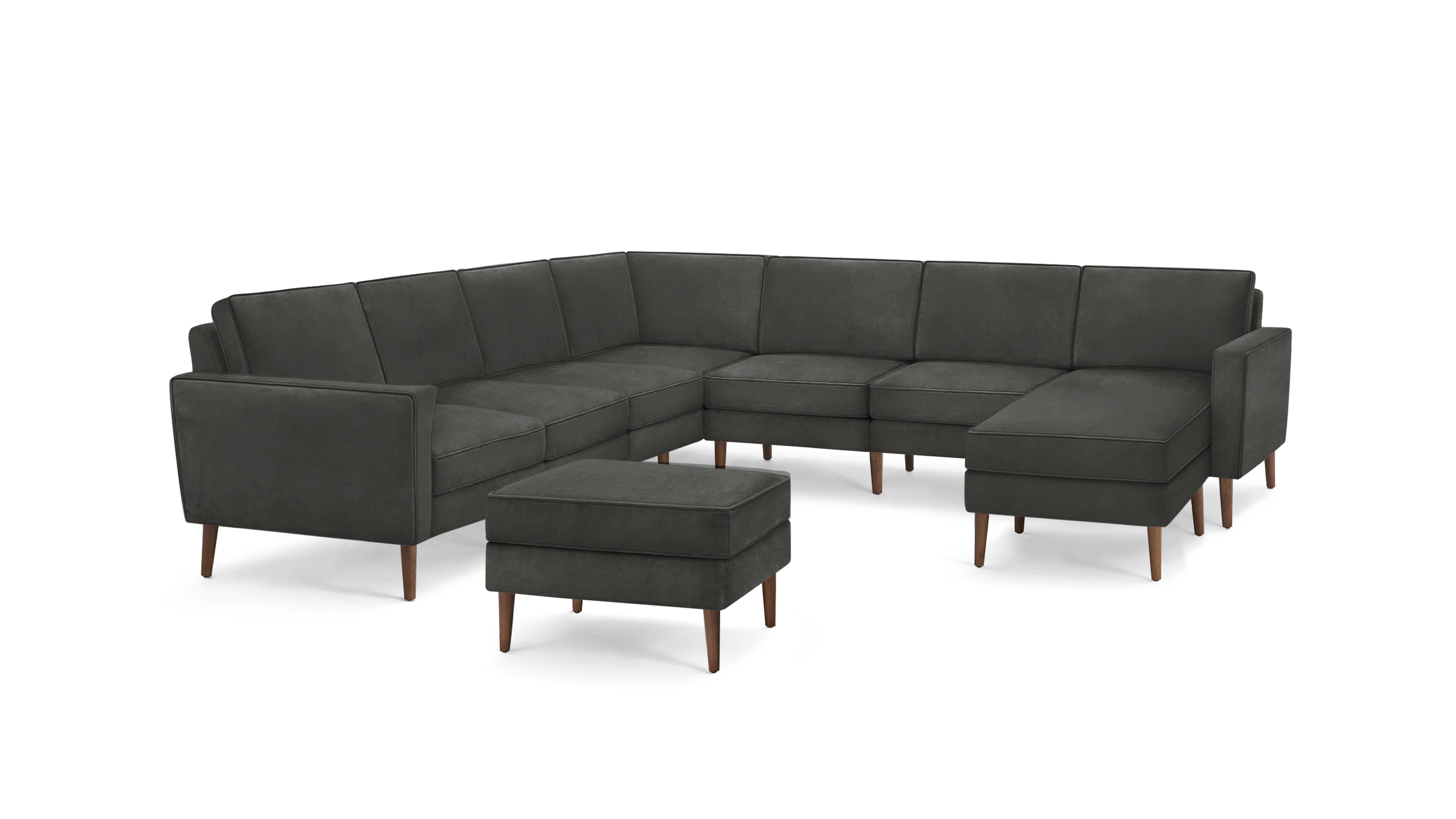 dark gray sectional sofa with wooden legs and matching ottoman, featuring a tufted backrest, matching ottoman, and matching ottoman