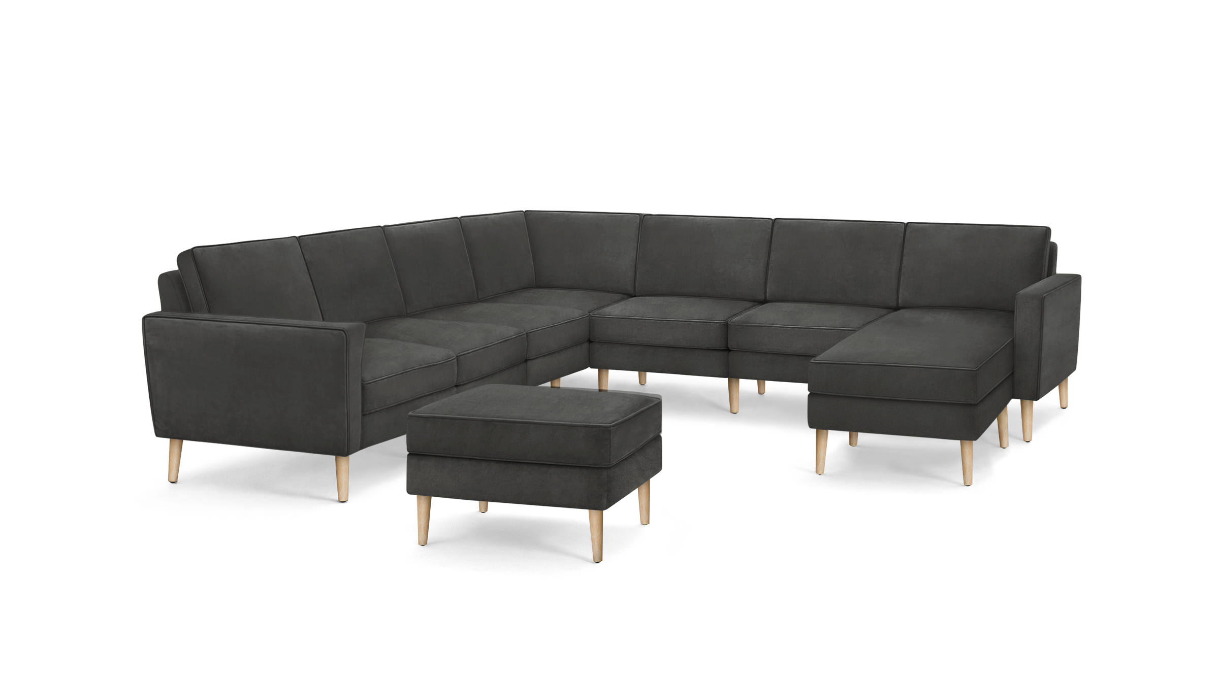 dark gray sectional sofa with wooden legs and matching ottoman, featuring a tufted backrest, and matching ottoman, featuring a matching ottoman