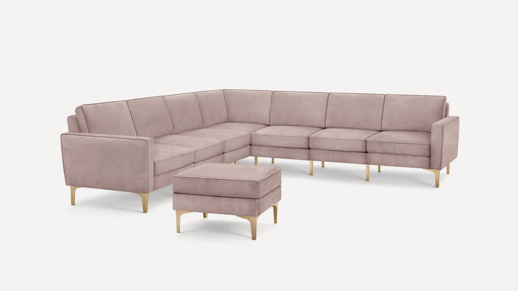 Light mauve velvet L-shaped sectional sofa with matching ottoman, gold metal legs, modern and minimalist design.