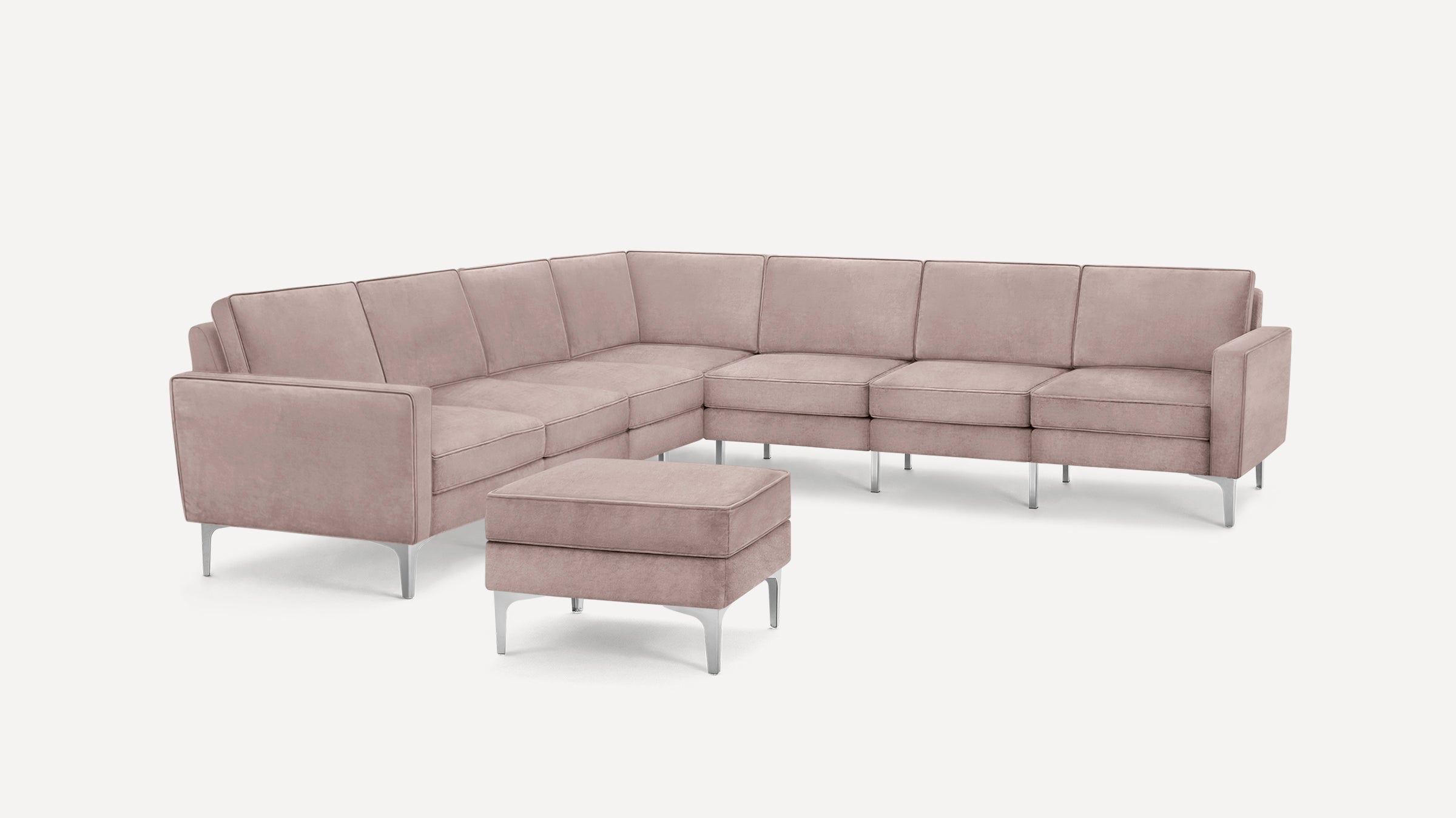 Modern L-shaped sectional sofa with soft mauve upholstery and sleek silver metal legs, accompanied by a matching square ottoman.