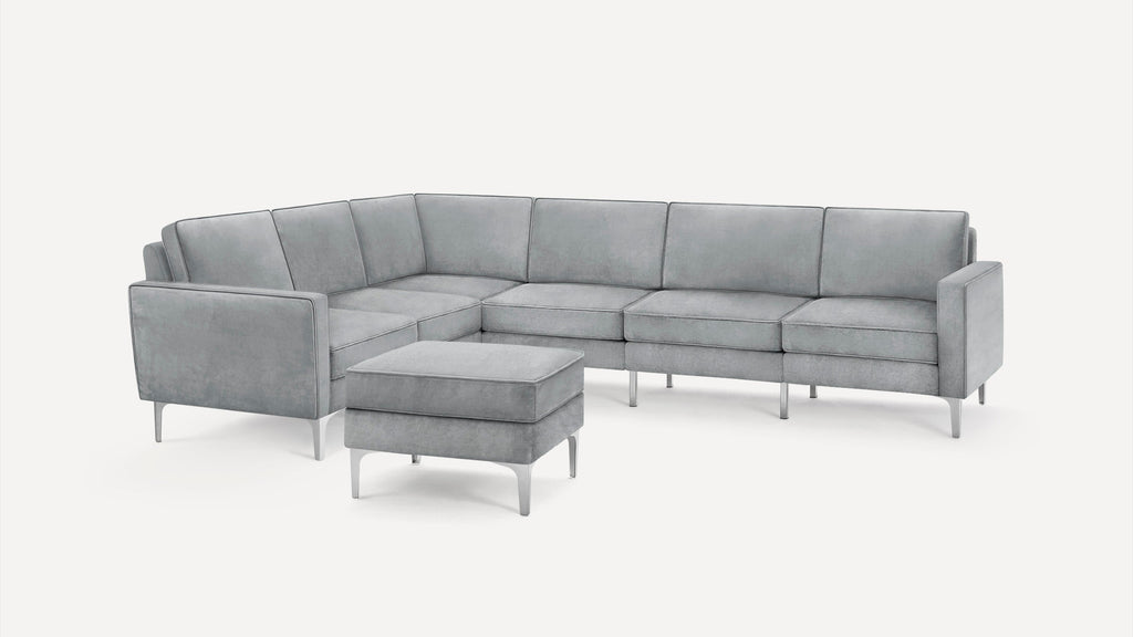 Modern gray sectional sofa with clean lines and a matching ottoman, supported by sleek metal legs, on a white background.