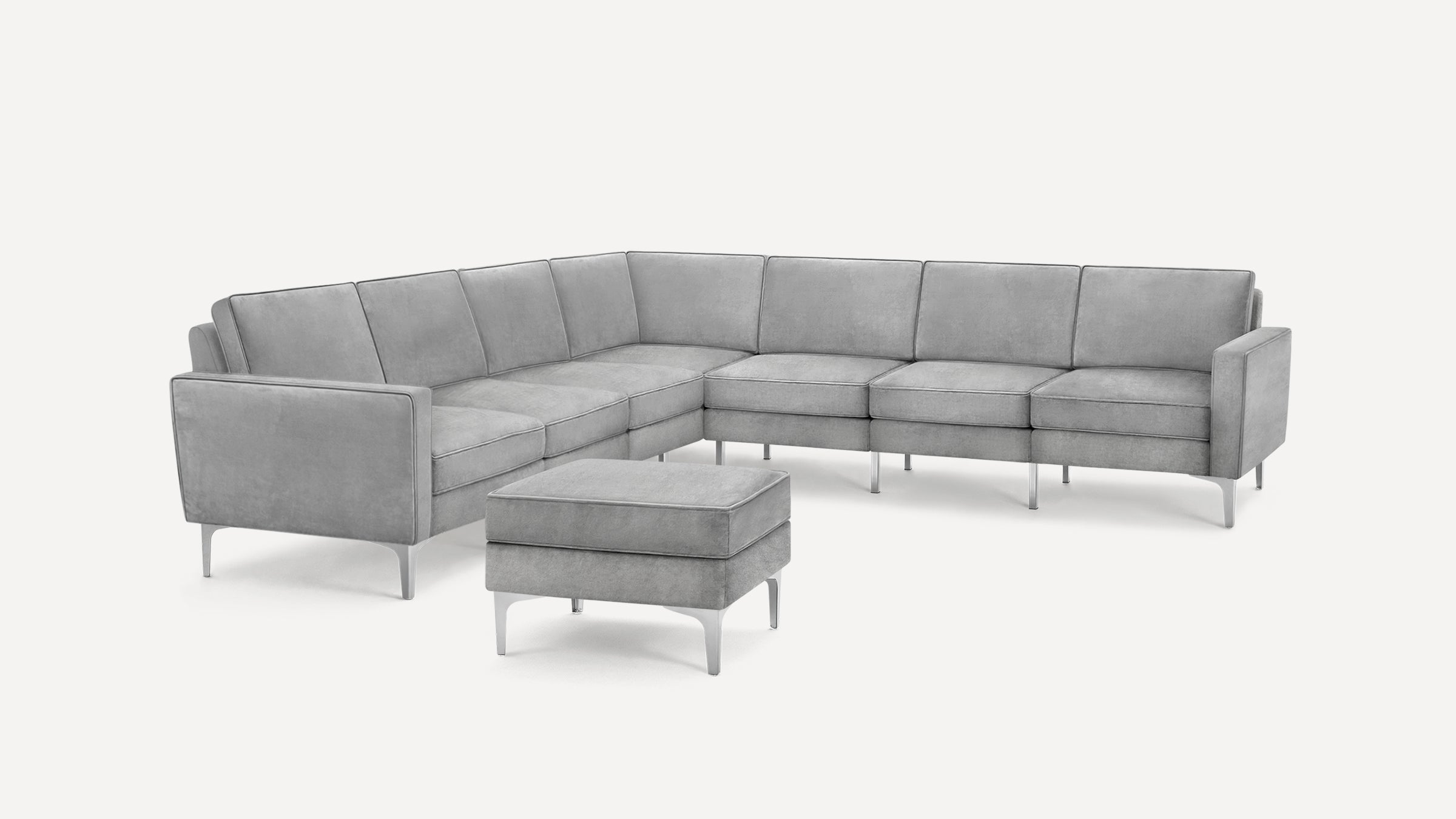 Modern light gray sectional sofa with clean lines, metal legs, and matching ottoman on a white background.