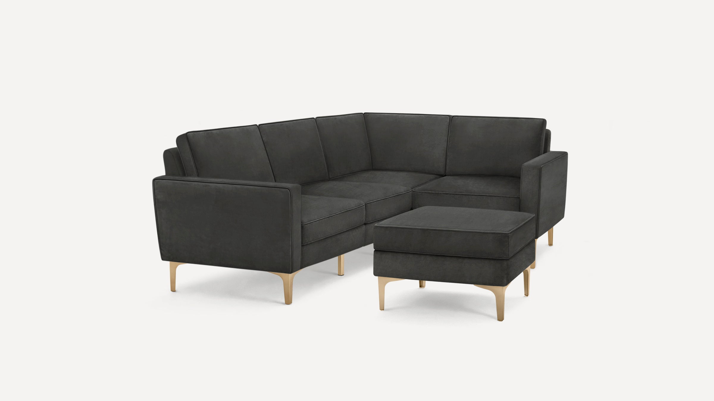 Modern dark gray sectional sofa with clean lines, plush cushions, and gold-toned metal legs, complemented by a matching ottoman.