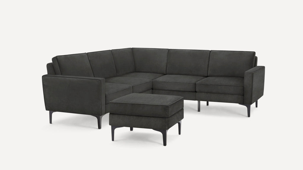 Dark gray modern sectional sofa with clean lines and slim legs, accompanied by a matching ottoman.